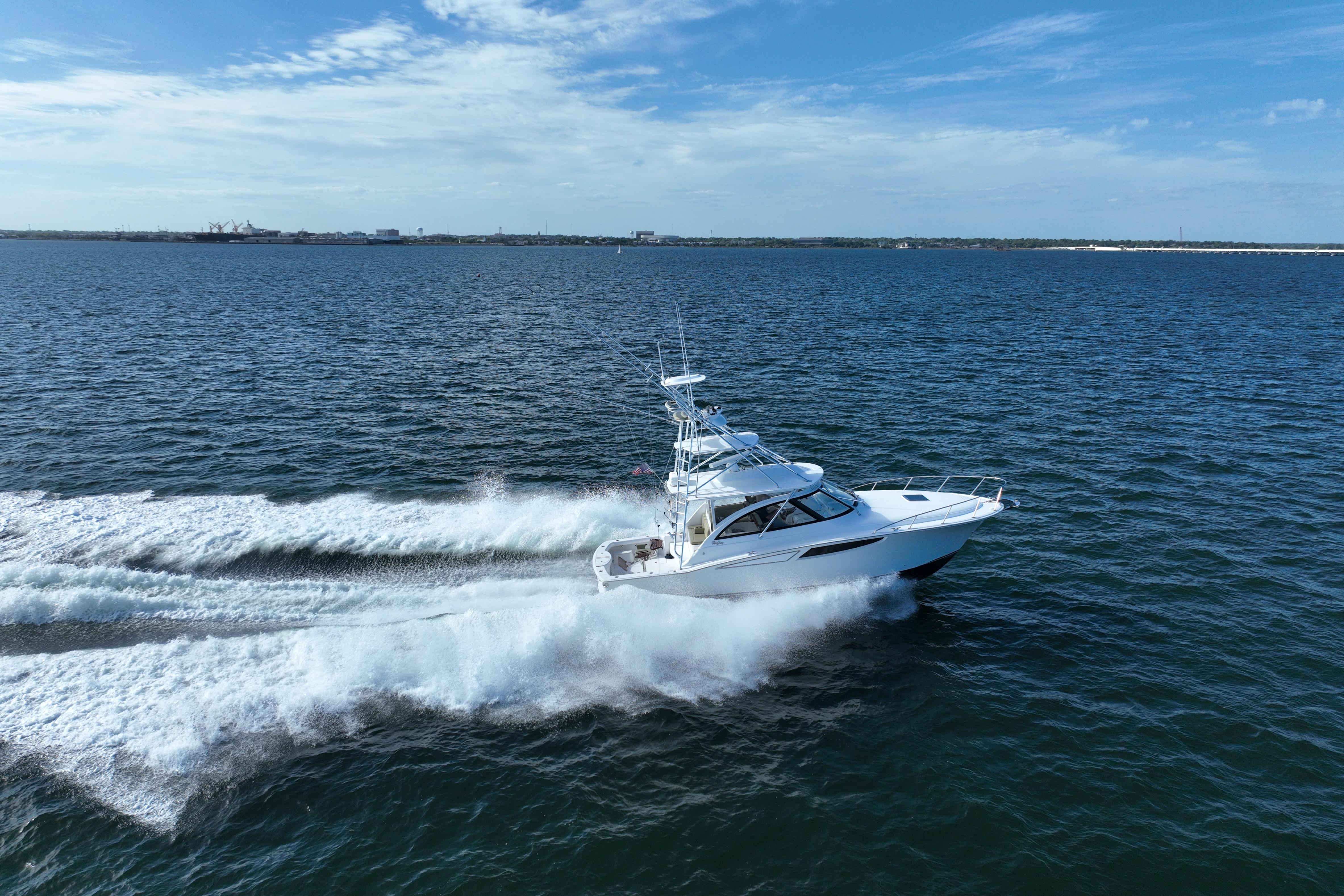 2020 Mag Bay 42 yacht cruising swiftly on open water under a clear blue sky.