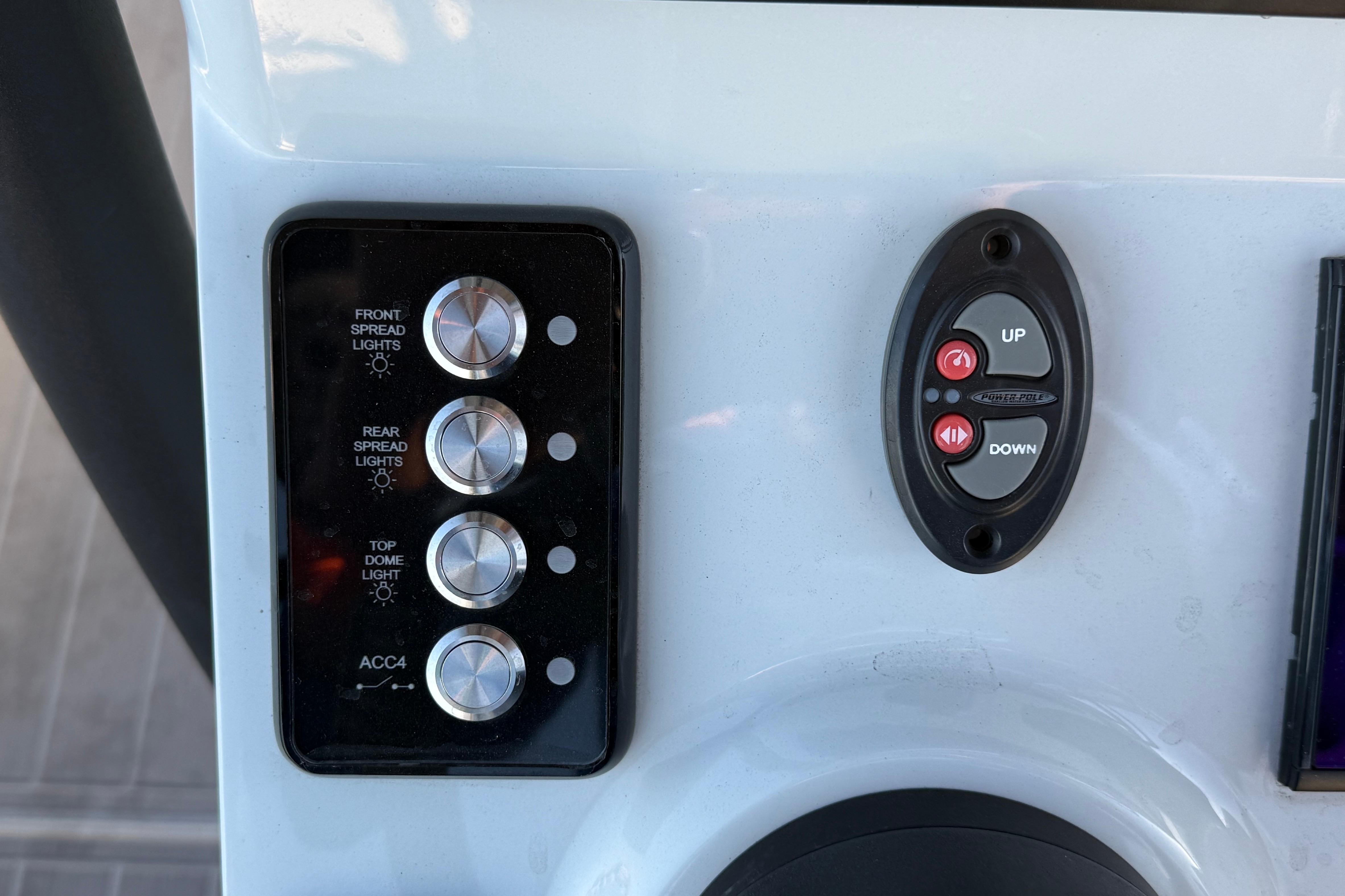 Control panel of 2025 Caymas 281 HB boat with light and power switches.