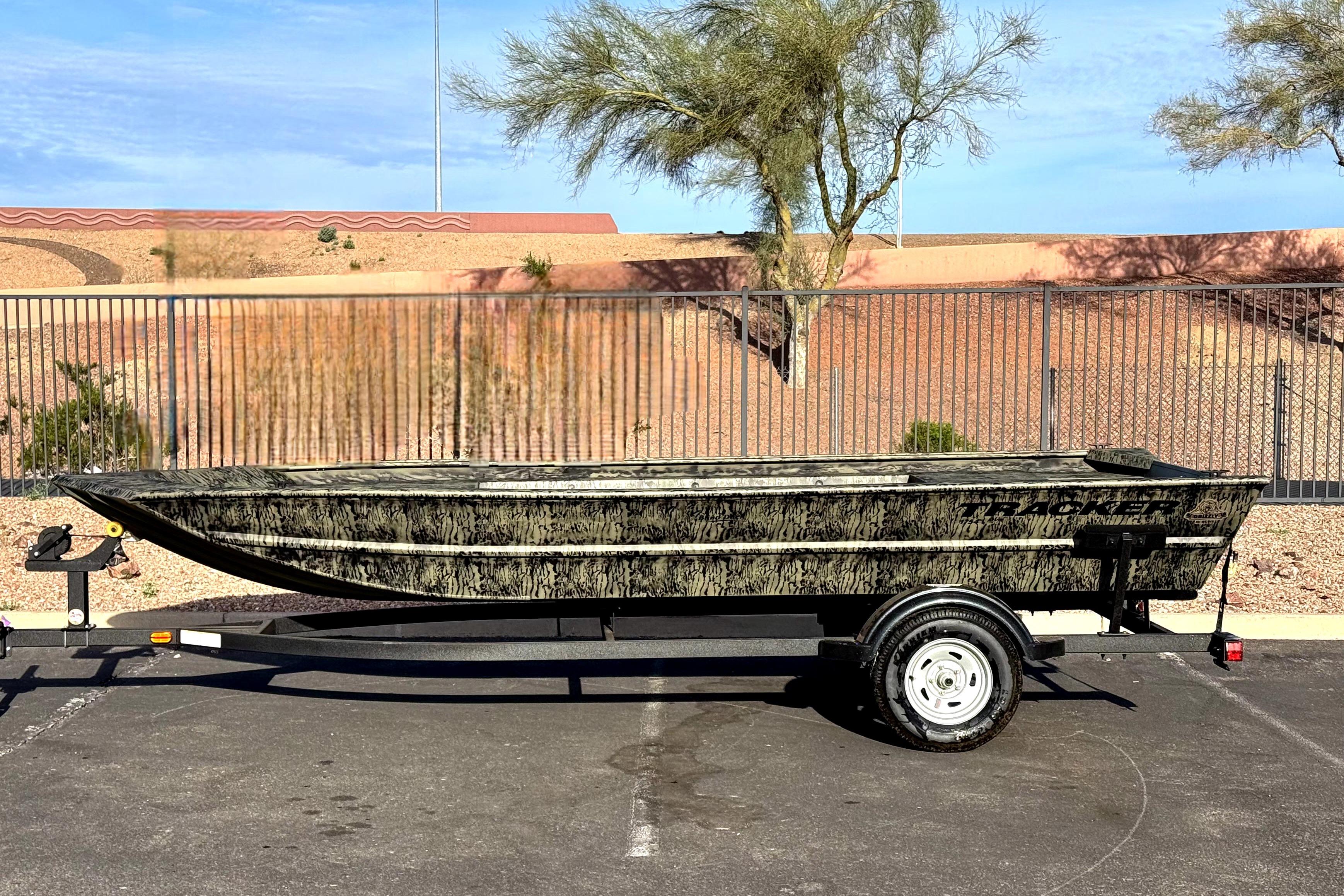 2026 Tracker Grizzly 1754 Utility boat on trailer, parked outdoors.