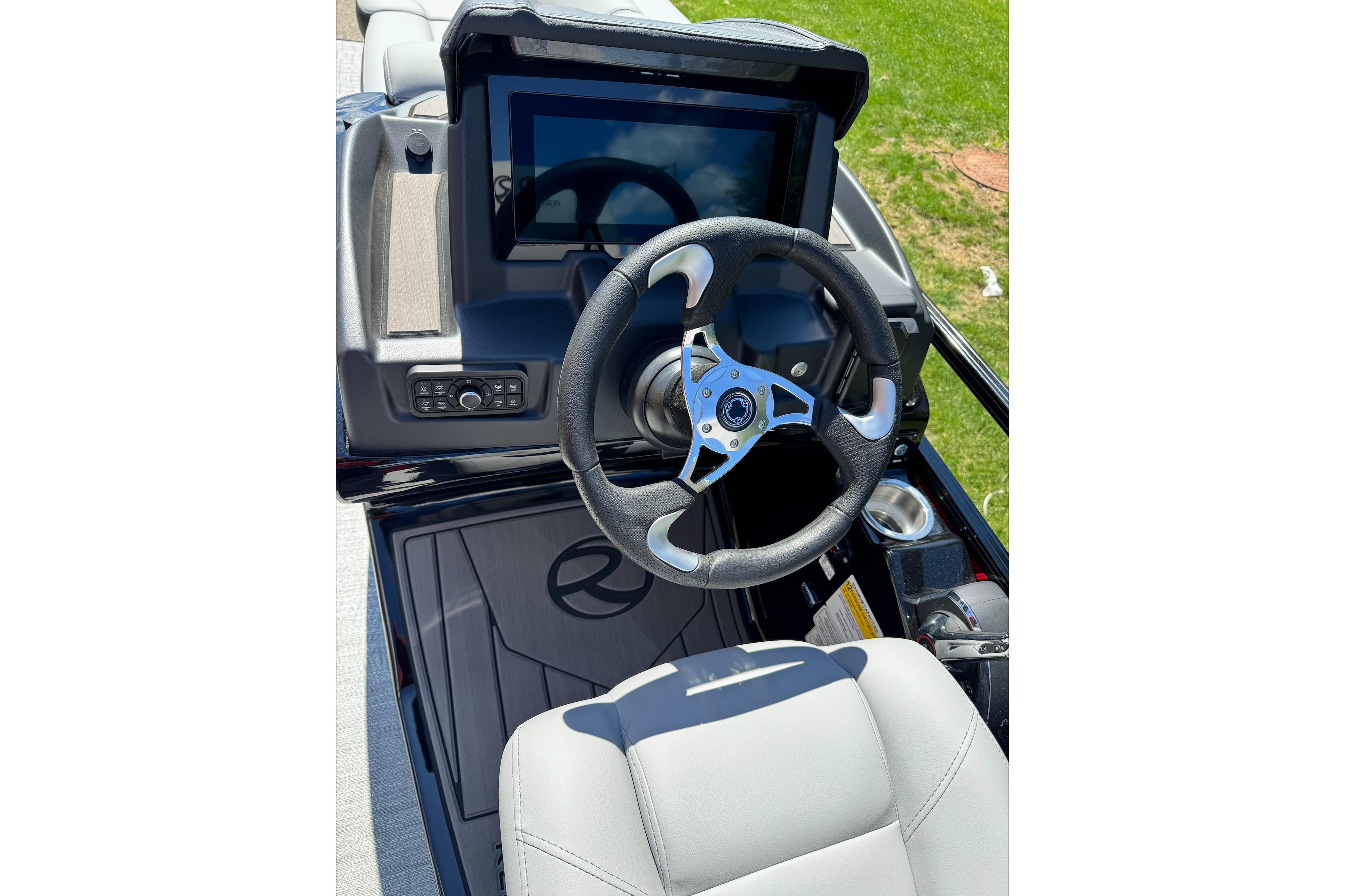 Steering console of 2026 Regency 230 DL boat with modern controls and touchscreen display.