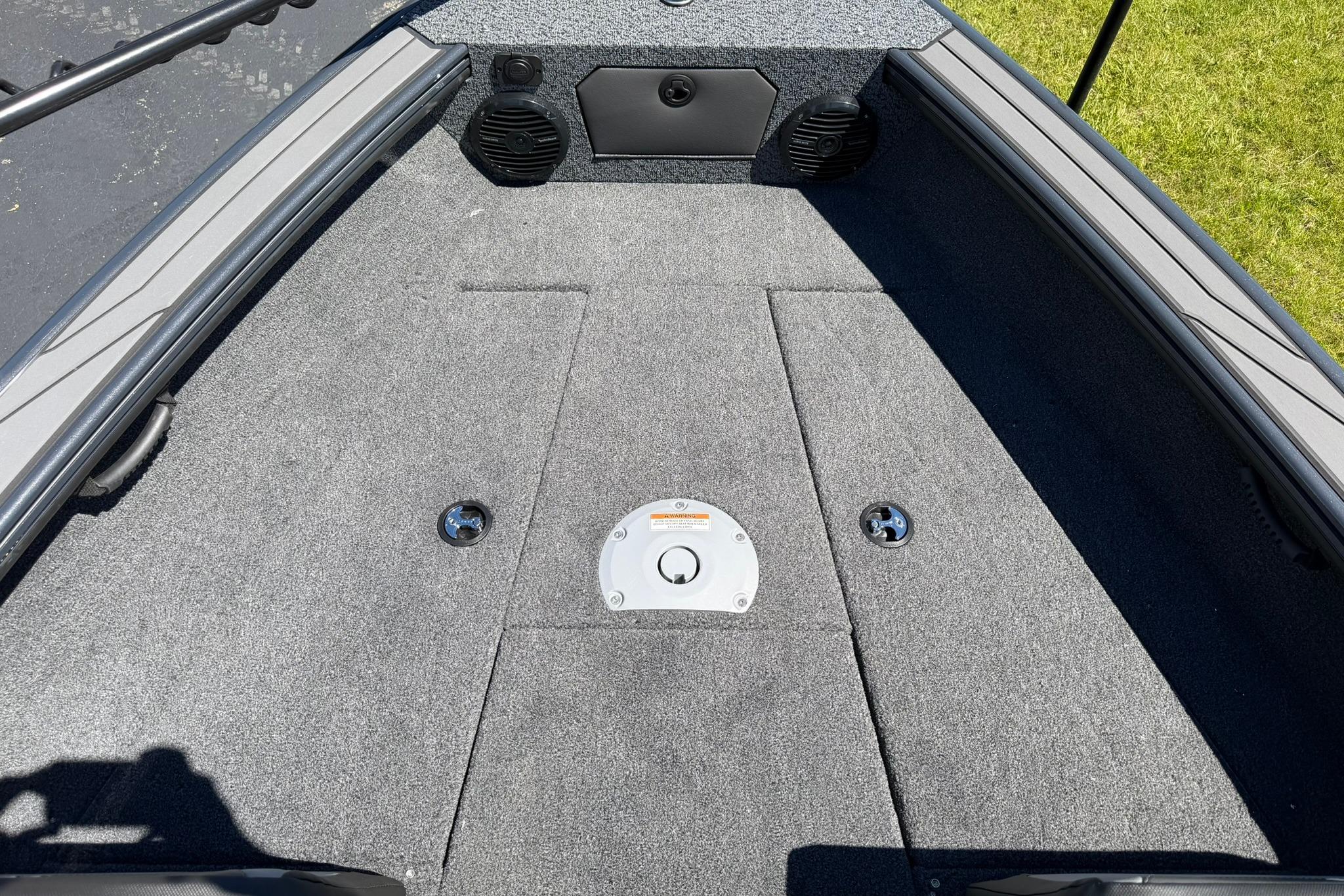 2027 Lund 1775 Crossover XS boat deck with carpeted surface and storage compartments.