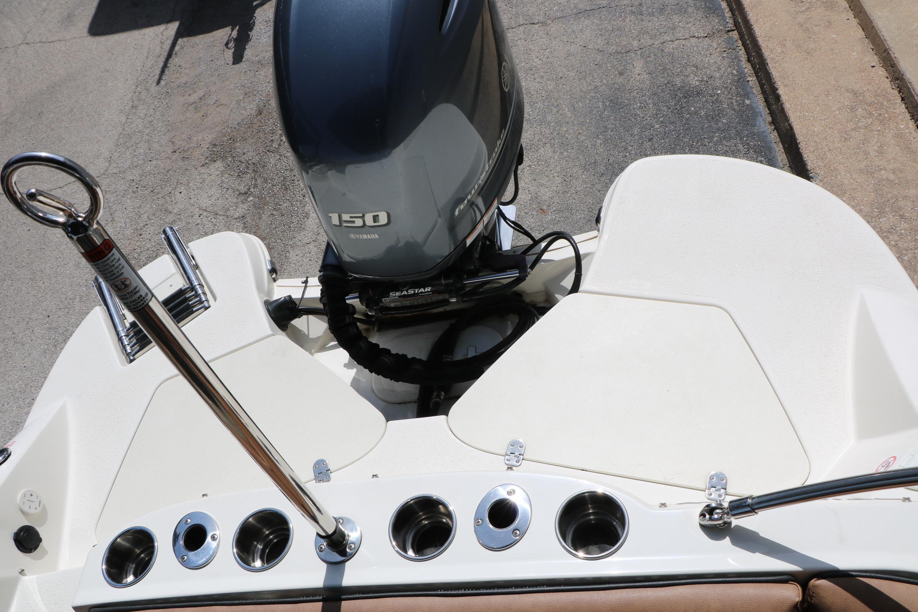 2022 Stingray 192 SC boat with Yamaha 150 engine, featuring cup holders and sleek design.