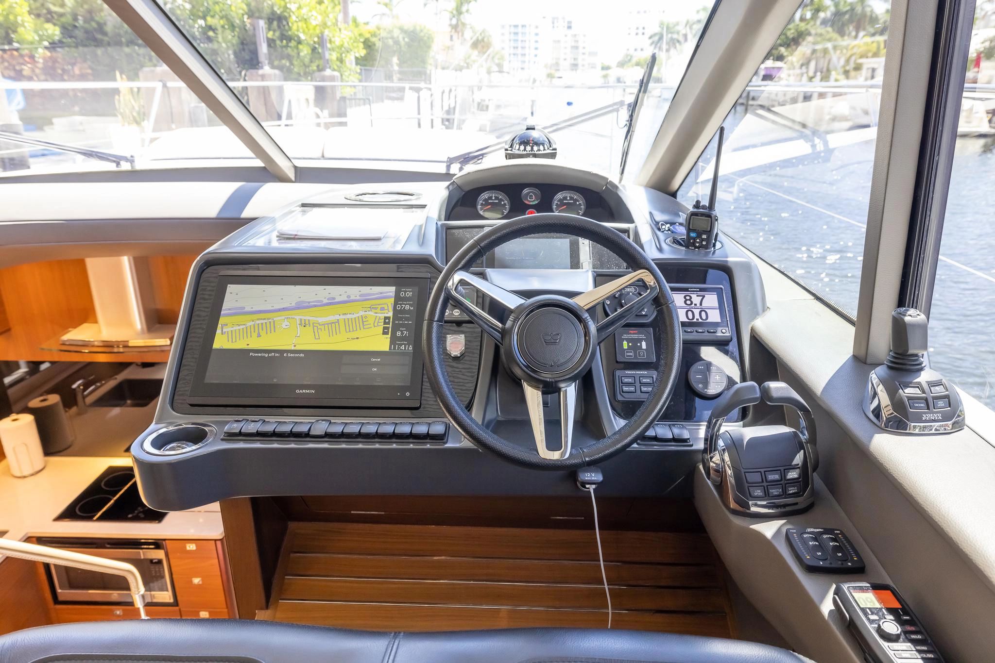 Interior view of the helm station on a 2020 Princess V50 yacht.