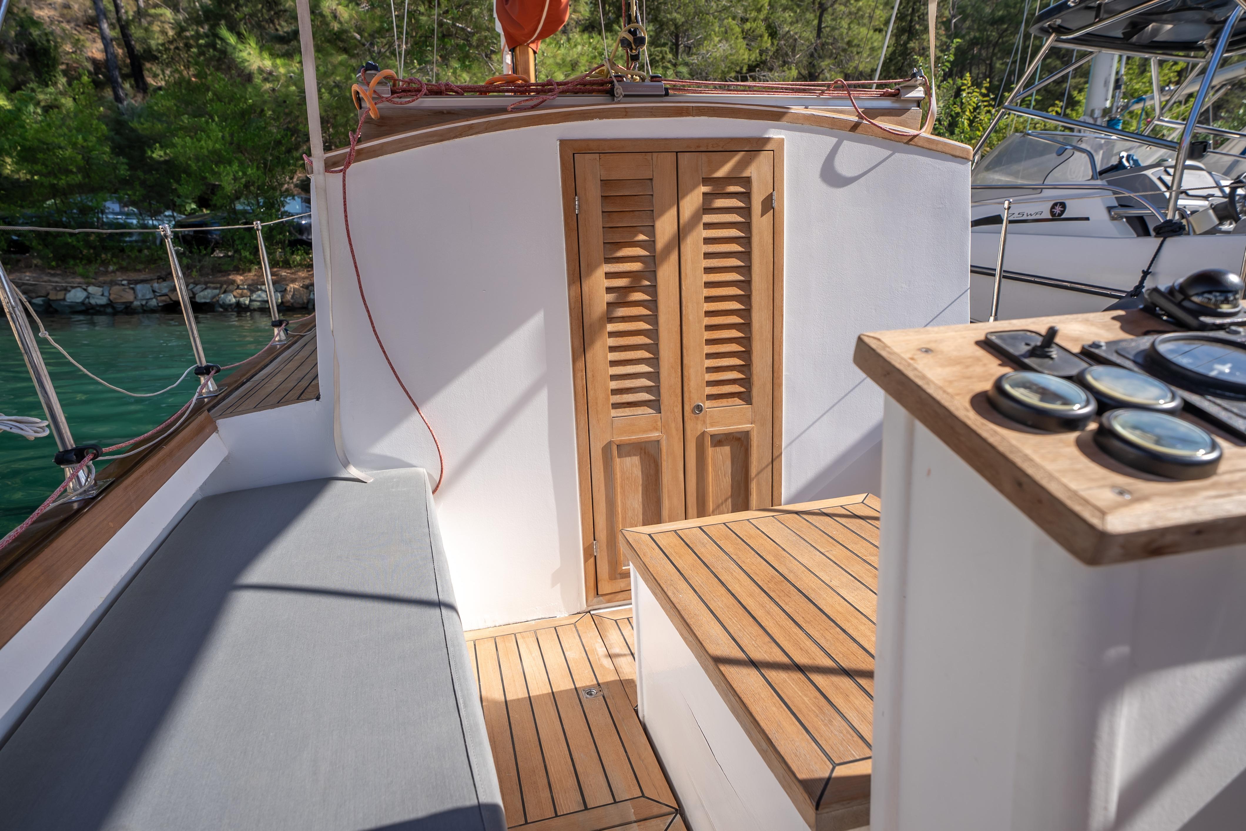 Custom 1999 Lykia boat interior with wooden doors and nautical instruments.