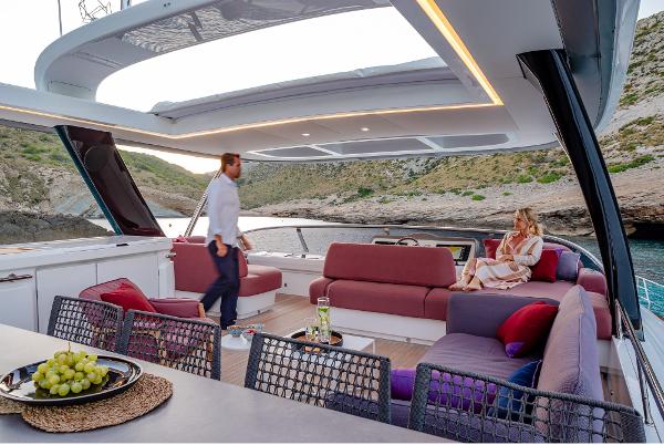Luxurious 2025 Lagoon SIXTY 7 yacht with spacious deck, modern seating, and scenic coastal view.
