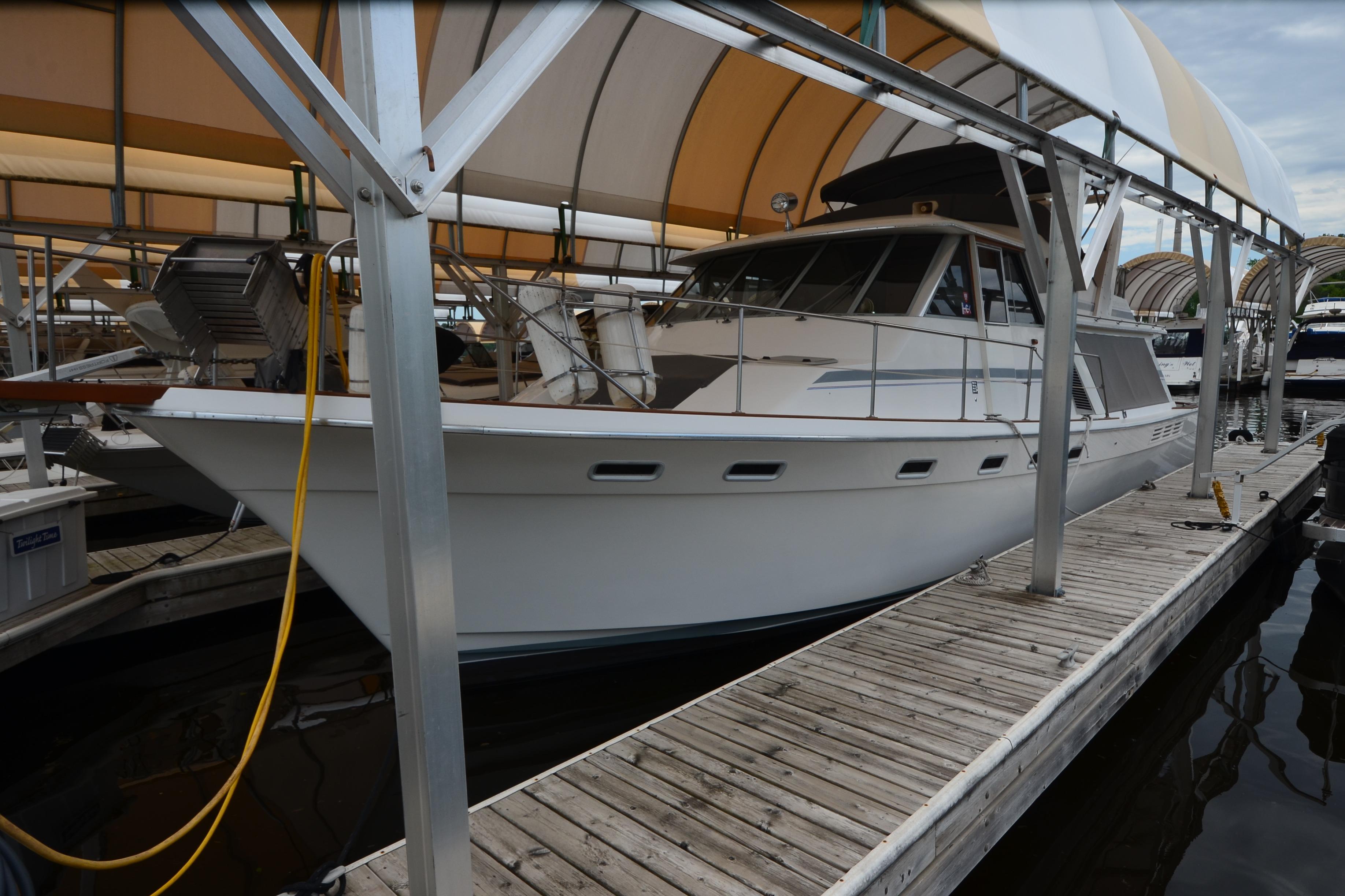 1989 Bayliner 4518 Motoryacht docked under covered marina.