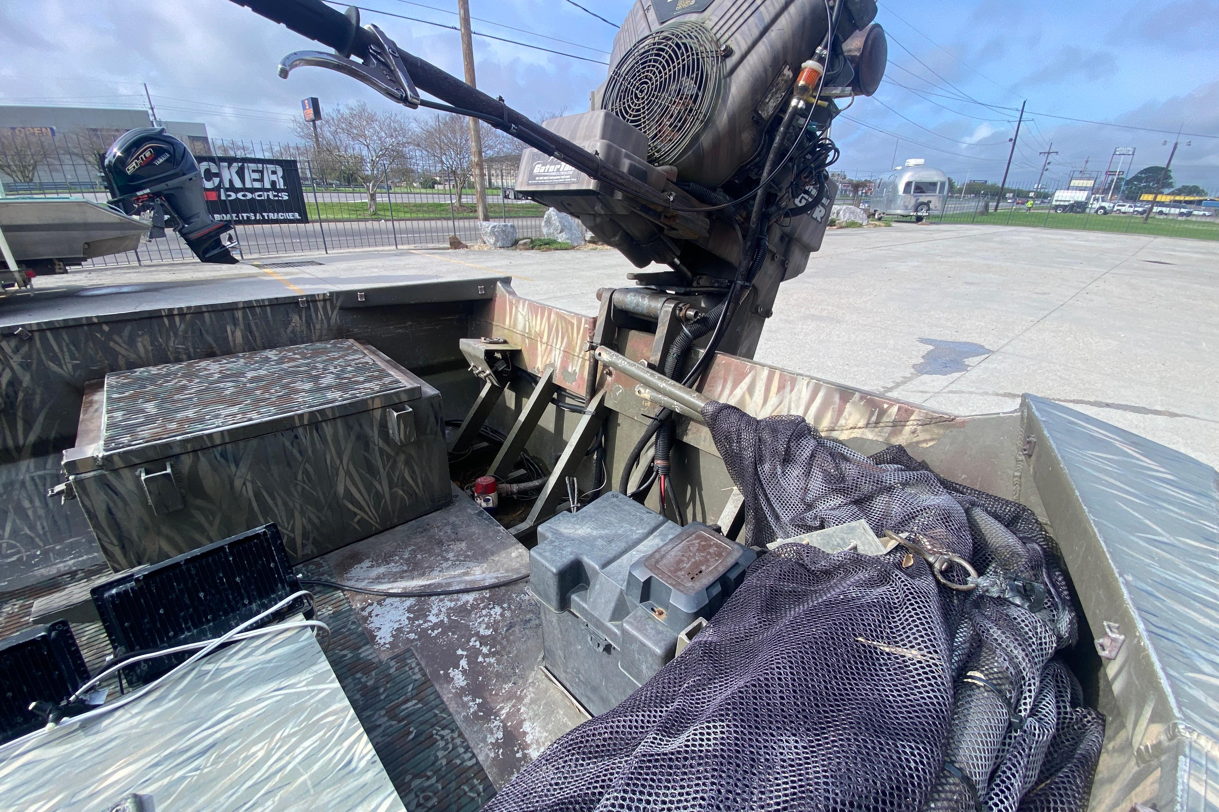 2009 Gator Trax MUD BUDDY 17 X 50 boat interior with motor and equipment.