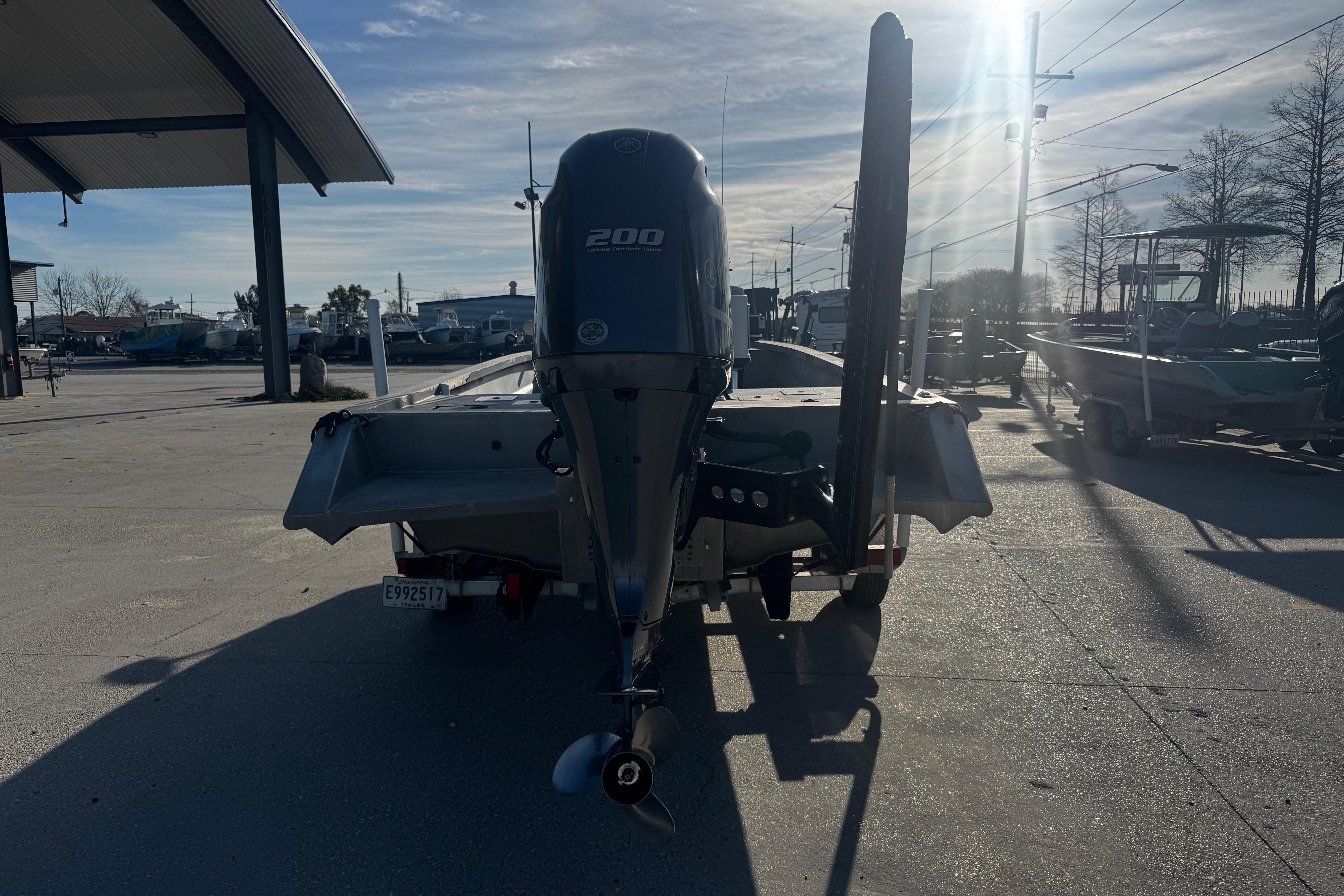 Rear view of a 2004 Custom Charles Leonard 21 boat with a 200 HP engine.