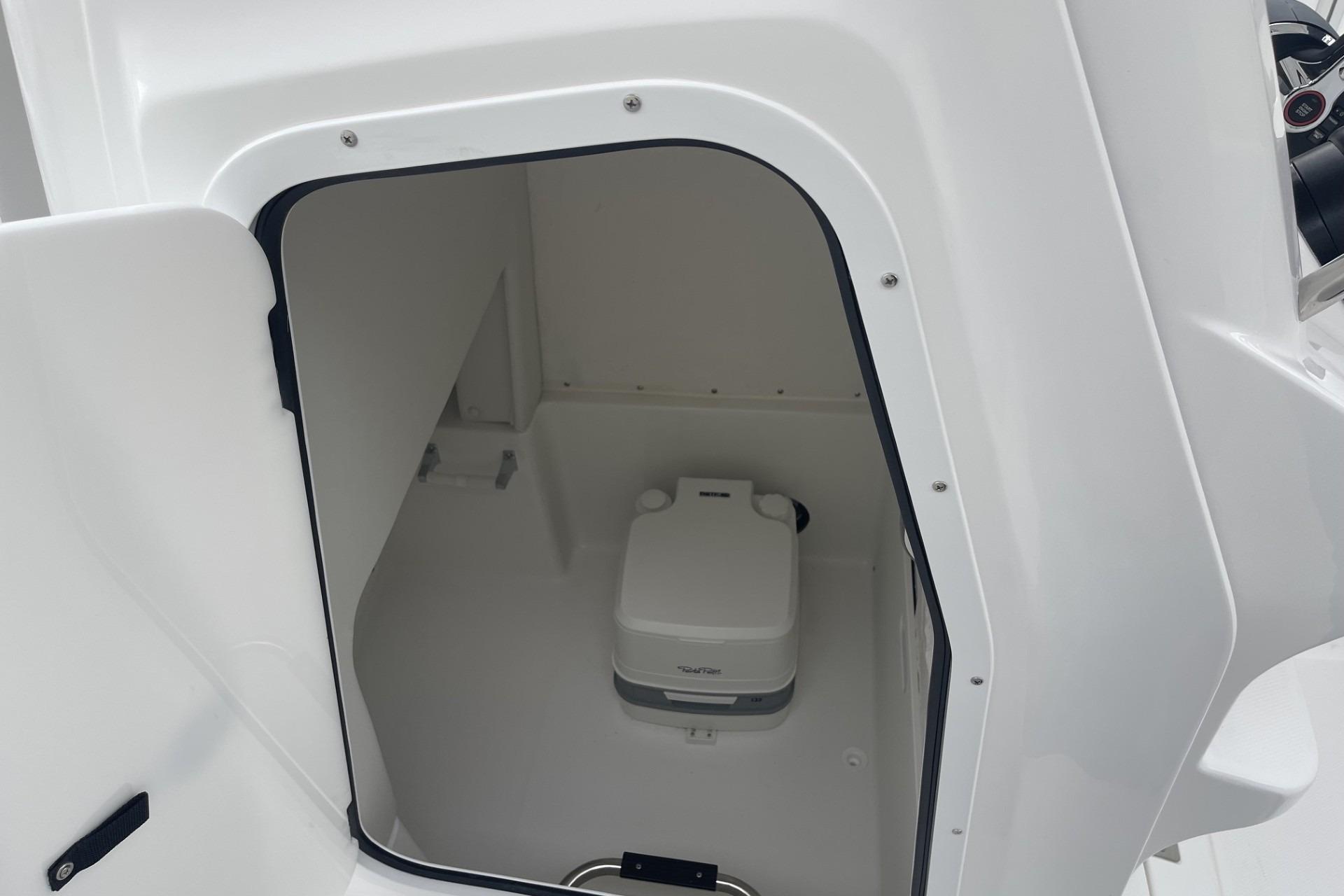 2026 Hurricane Center Console 24 OB boat interior with compact marine toilet.