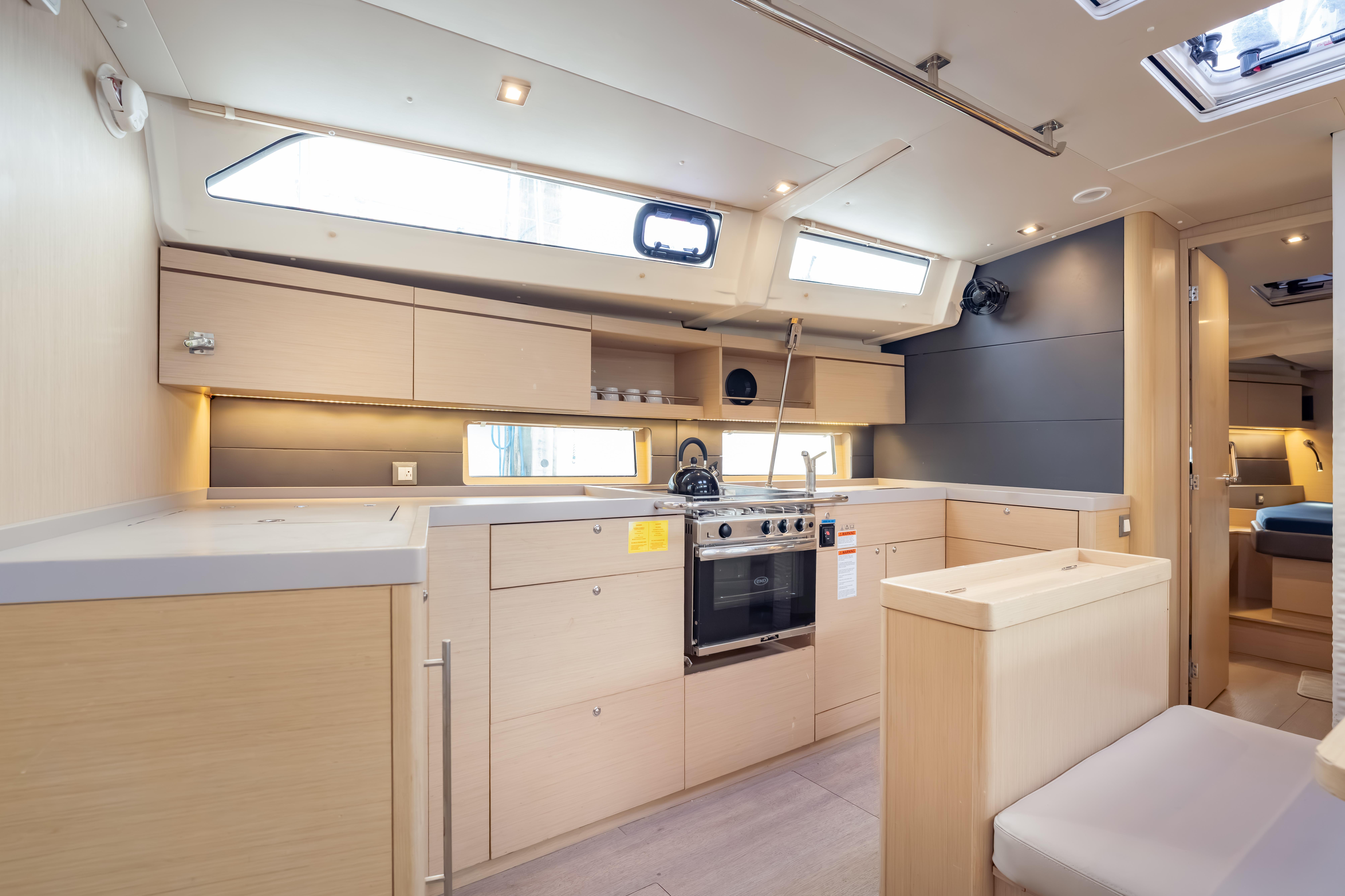 Modern kitchen interior of 2020 Beneteau Oceanis 46.1 yacht, featuring sleek cabinetry and appliances.