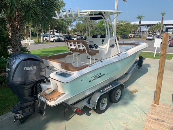2025 Pioneer 222 Islander boat with Yamaha engine on a trailer, parked outdoors.