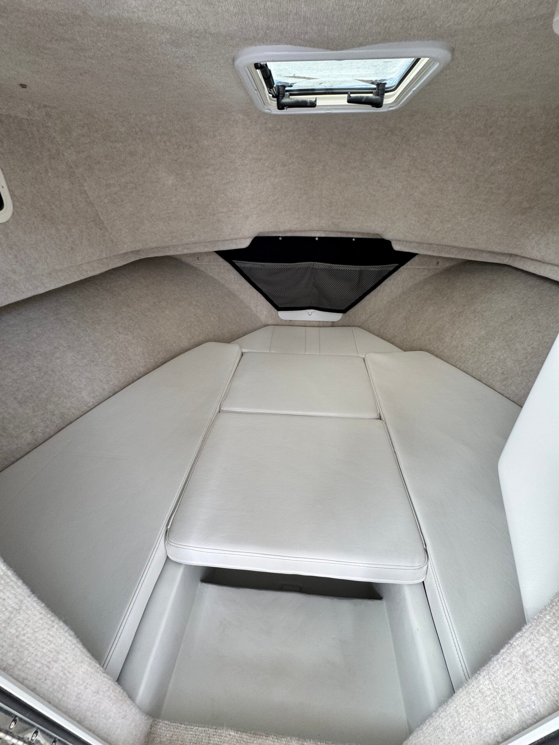 Interior of a 2021 Regal 26 Express with cushioned seating and a skylight.