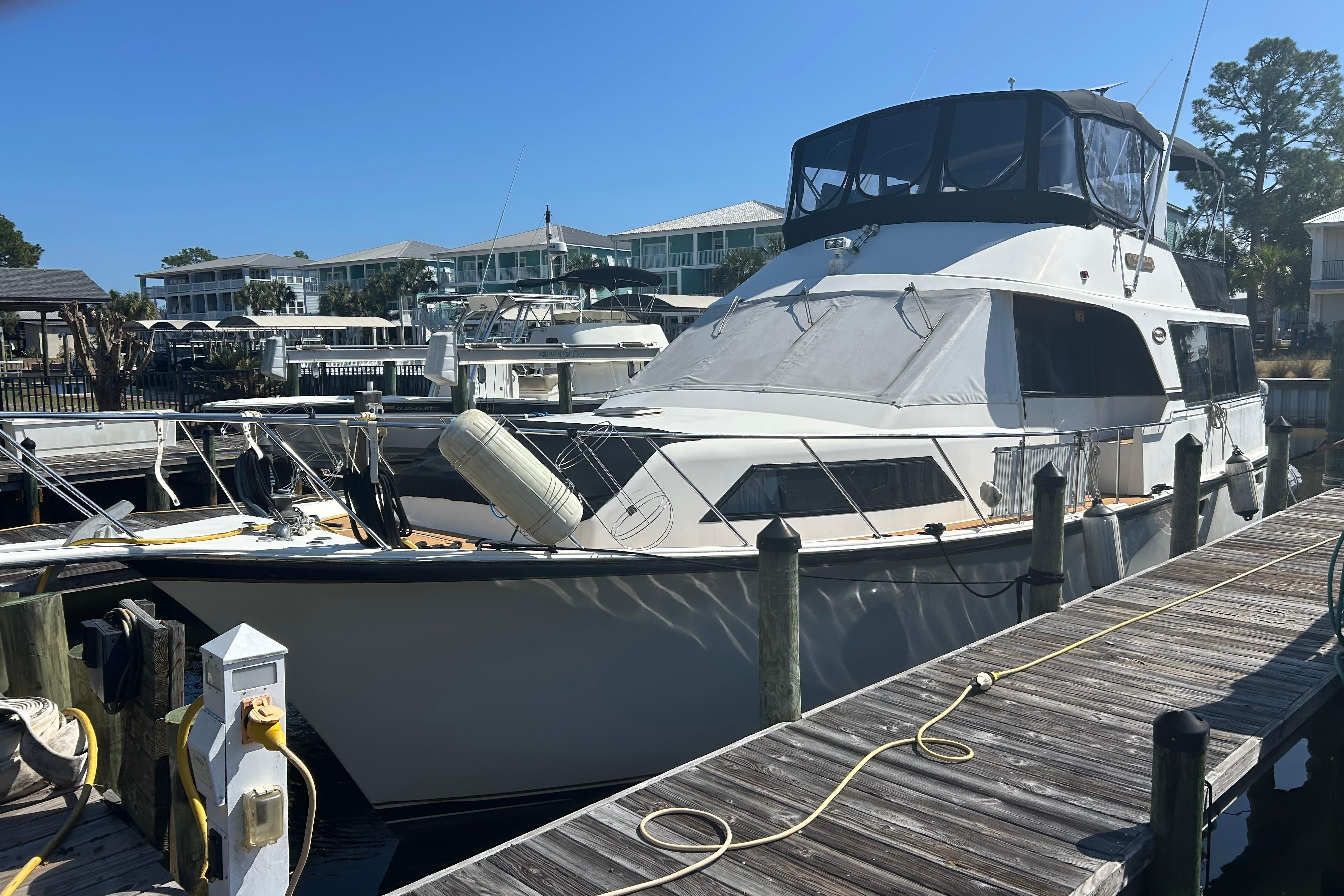 1989 Ocean 48 Motor Yacht docked at marina under clear blue sky.
