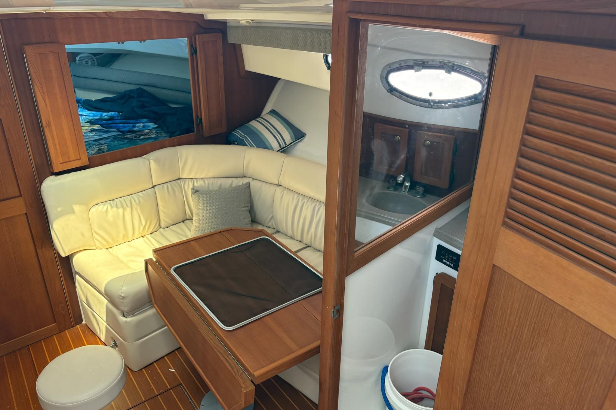 2008 Stamas 370 Express cabin interior with cozy seating and wooden finishes.