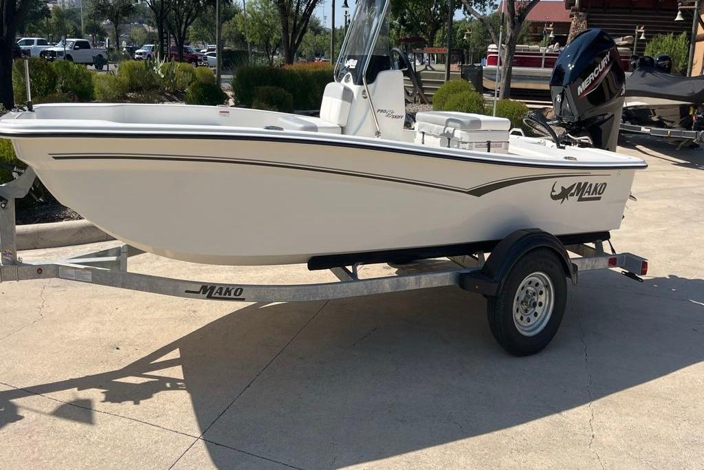 2026 Mako Pro Skiff 15 CC boat on trailer, parked outdoors.