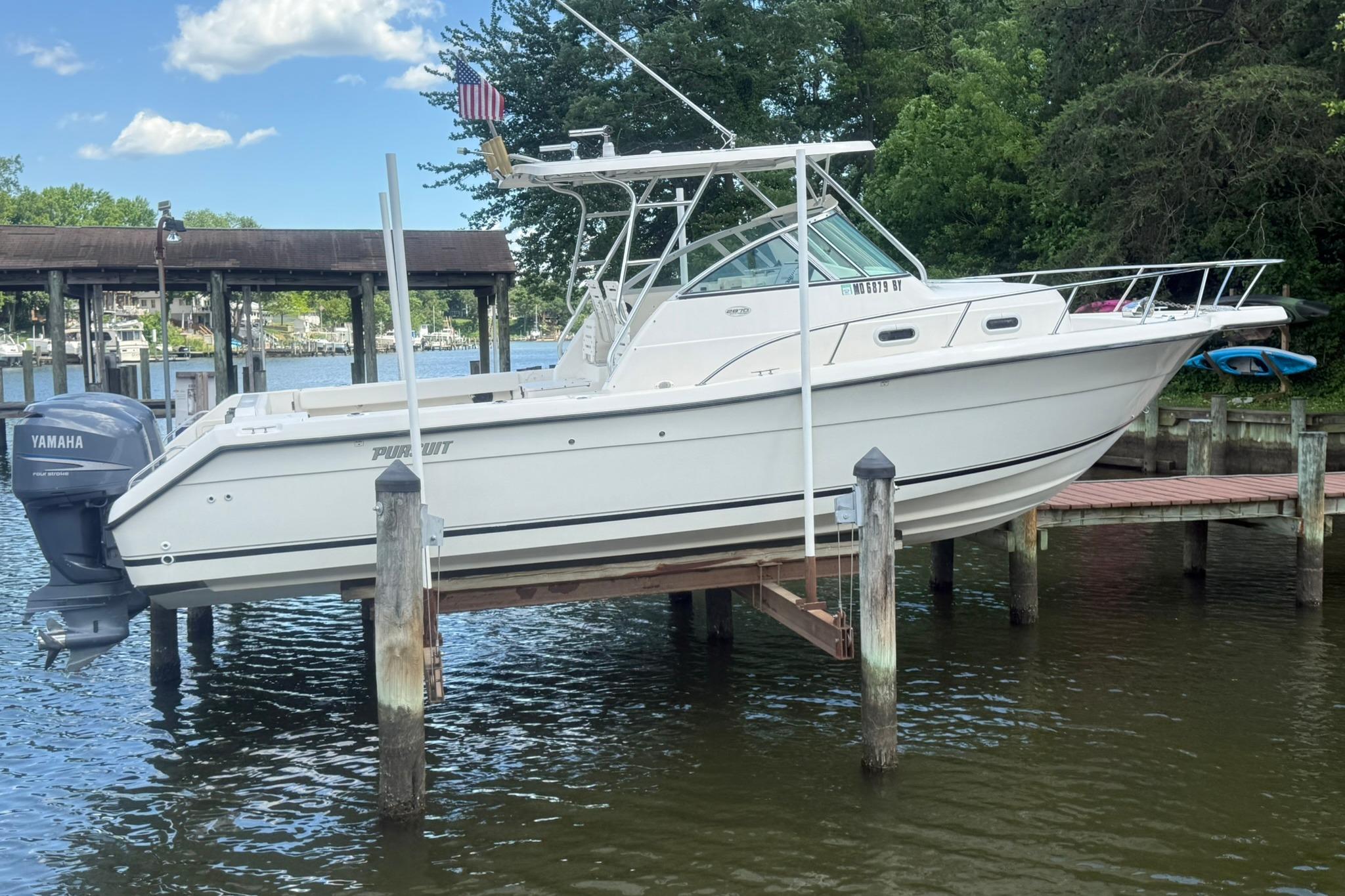 2003 Pursuit 2870 Walkaround boat docked with Yamaha outboard motor.