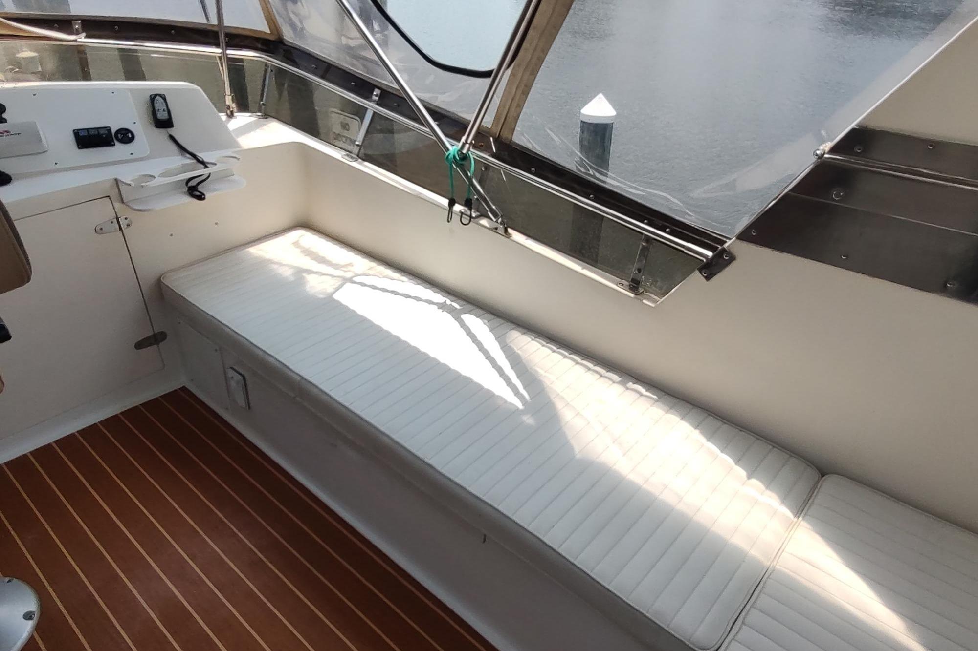 1989 Hyatt Double Cabin Motoryacht interior with white seating and wooden flooring.