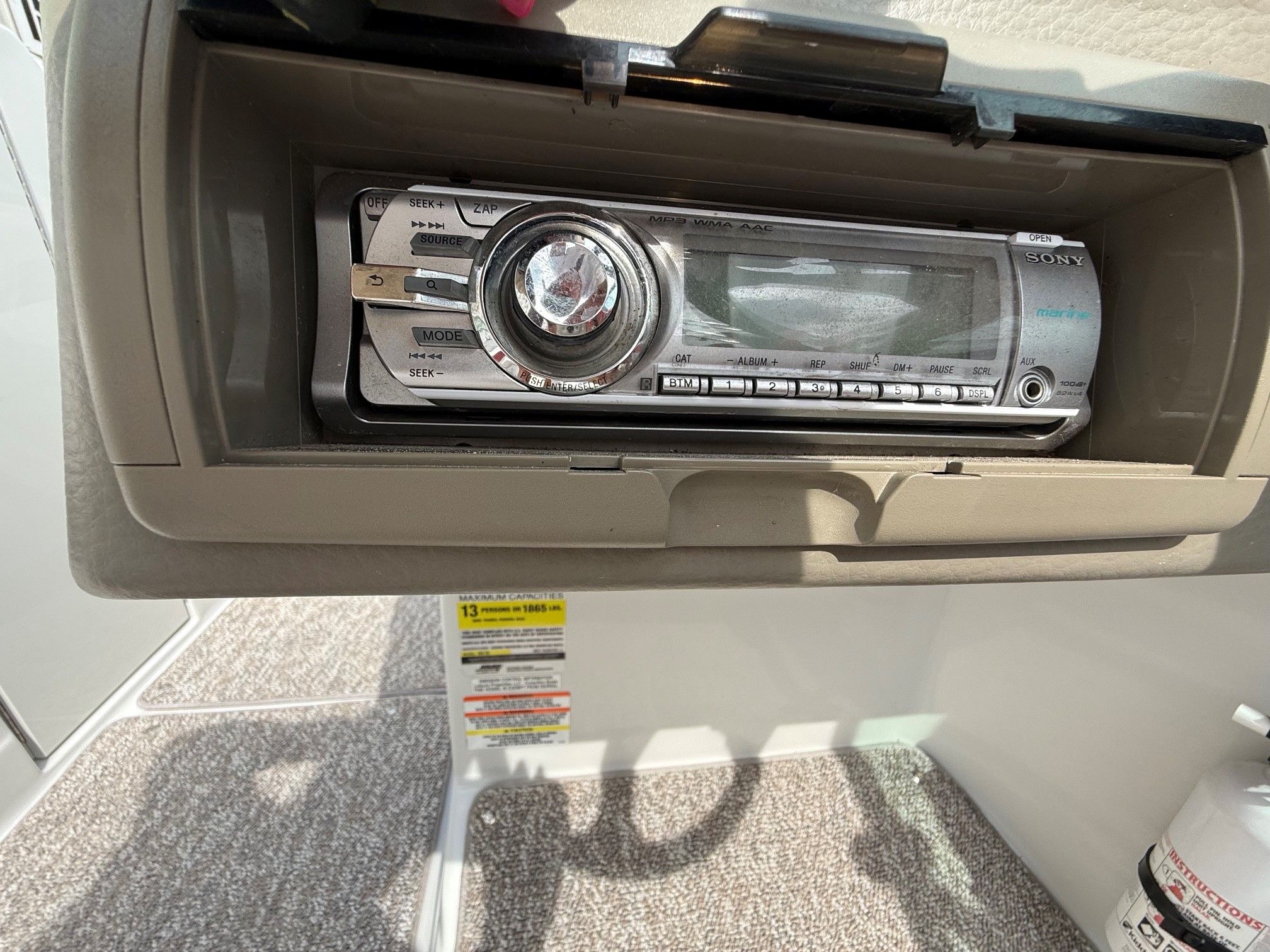 A Sony car stereo is installed in a compartment of a Crownline 252 EX boat.