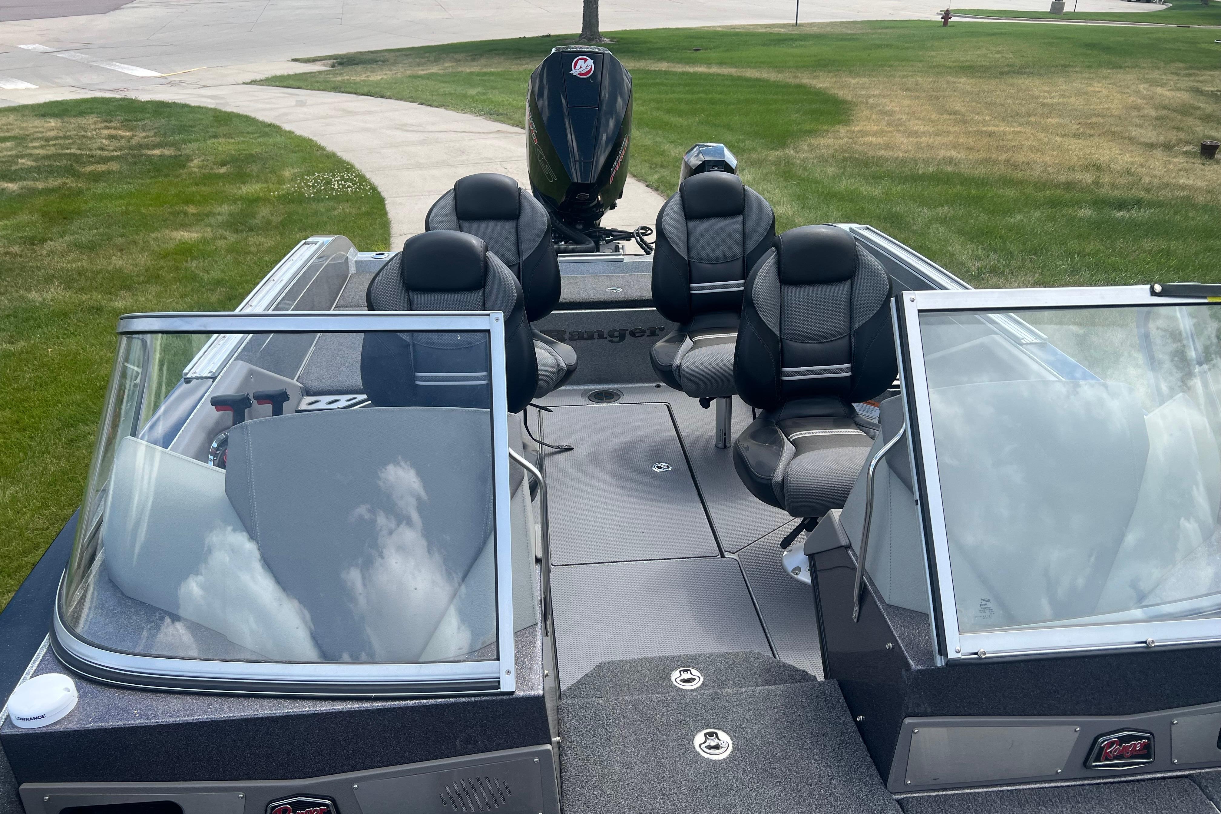 2023 Ranger 620FS Pro boat interior with seating and windshield, parked on grass.