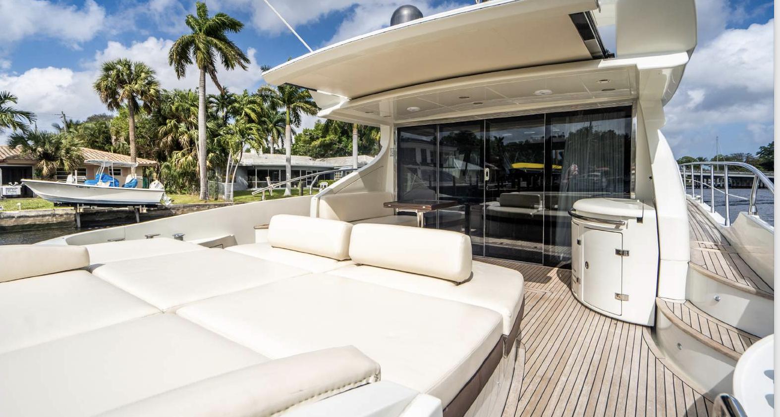 Luxurious 2005 Azimut 68S yacht deck with plush seating and sleek design.