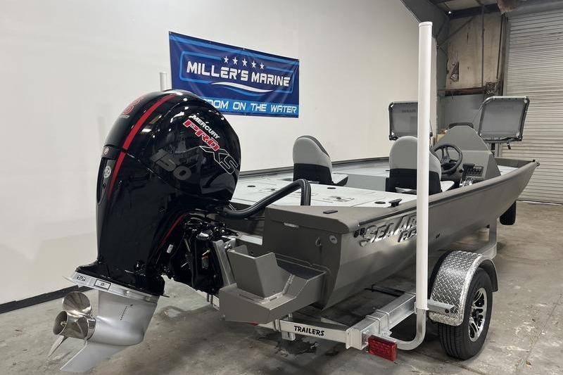 2026 SeaArk Flex 19 Pro boat with powerful outboard motor in showroom.