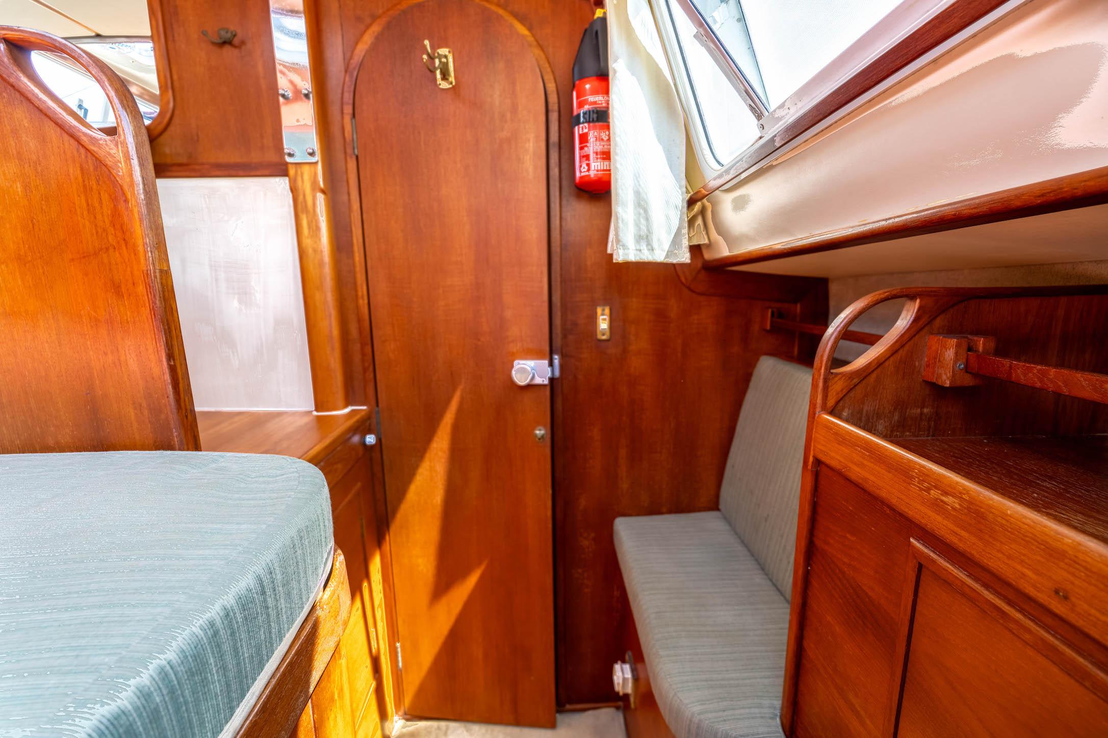 Interior of a 1994 Catalac 11 Meter boat with wooden finishes and seating area.