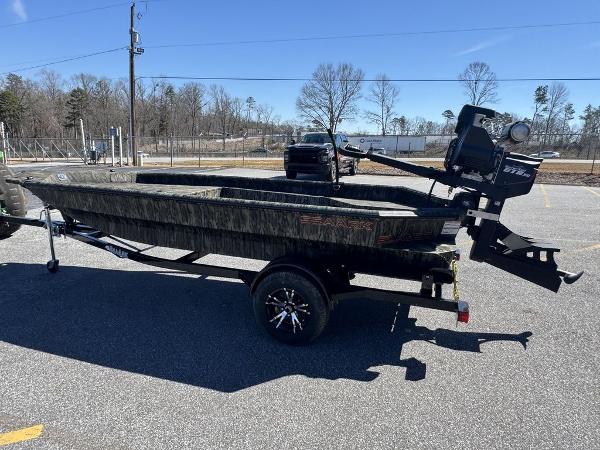 2025 SeaArk 1752 Slayer Pro boat on trailer in parking lot, side view.