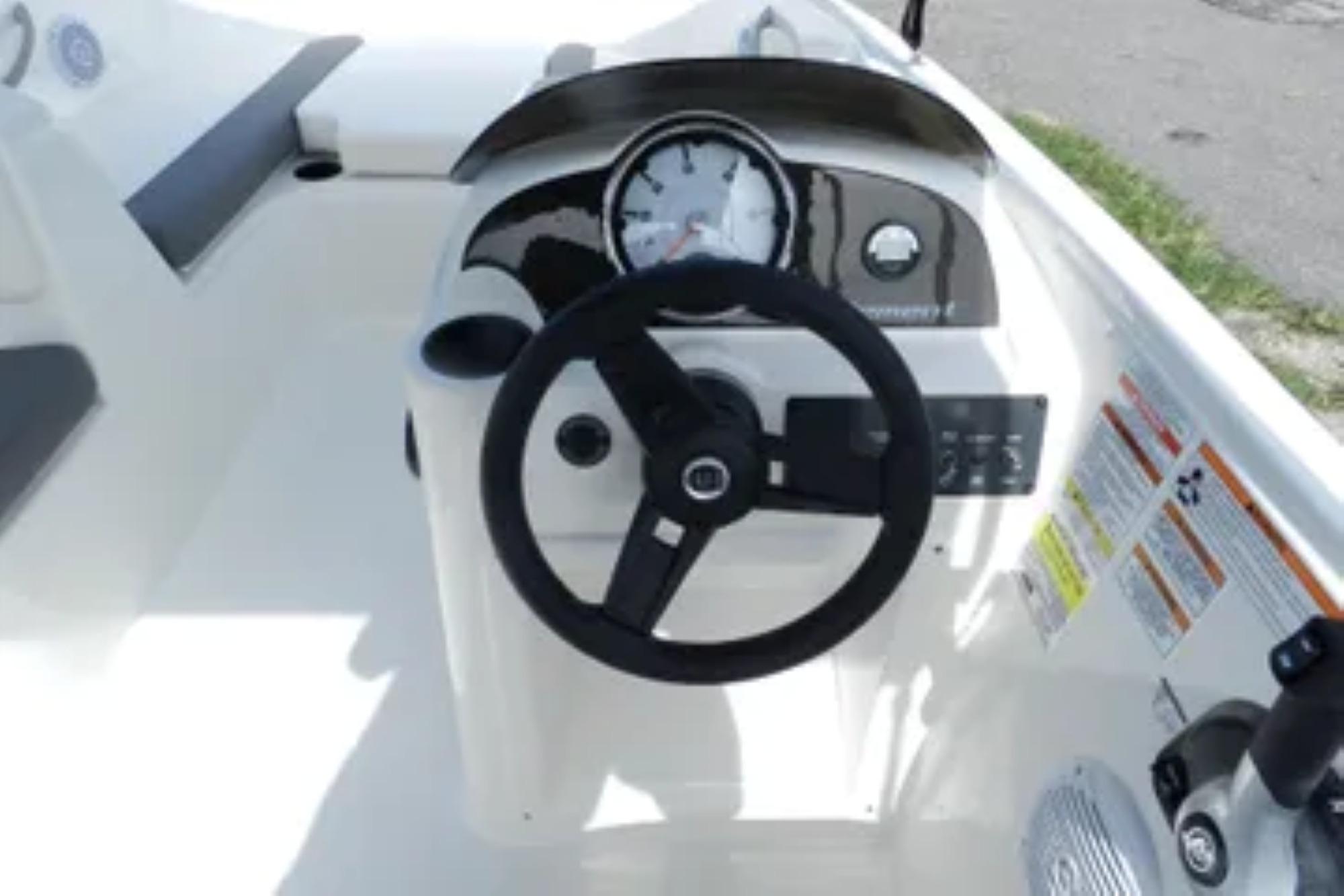 2026 Bayliner Element E18 boat dashboard with steering wheel and control panel.