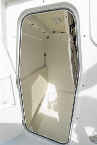 Interior cabin of 2025 Sea Hunt Ultra 235 SE boat, featuring sleek white design.