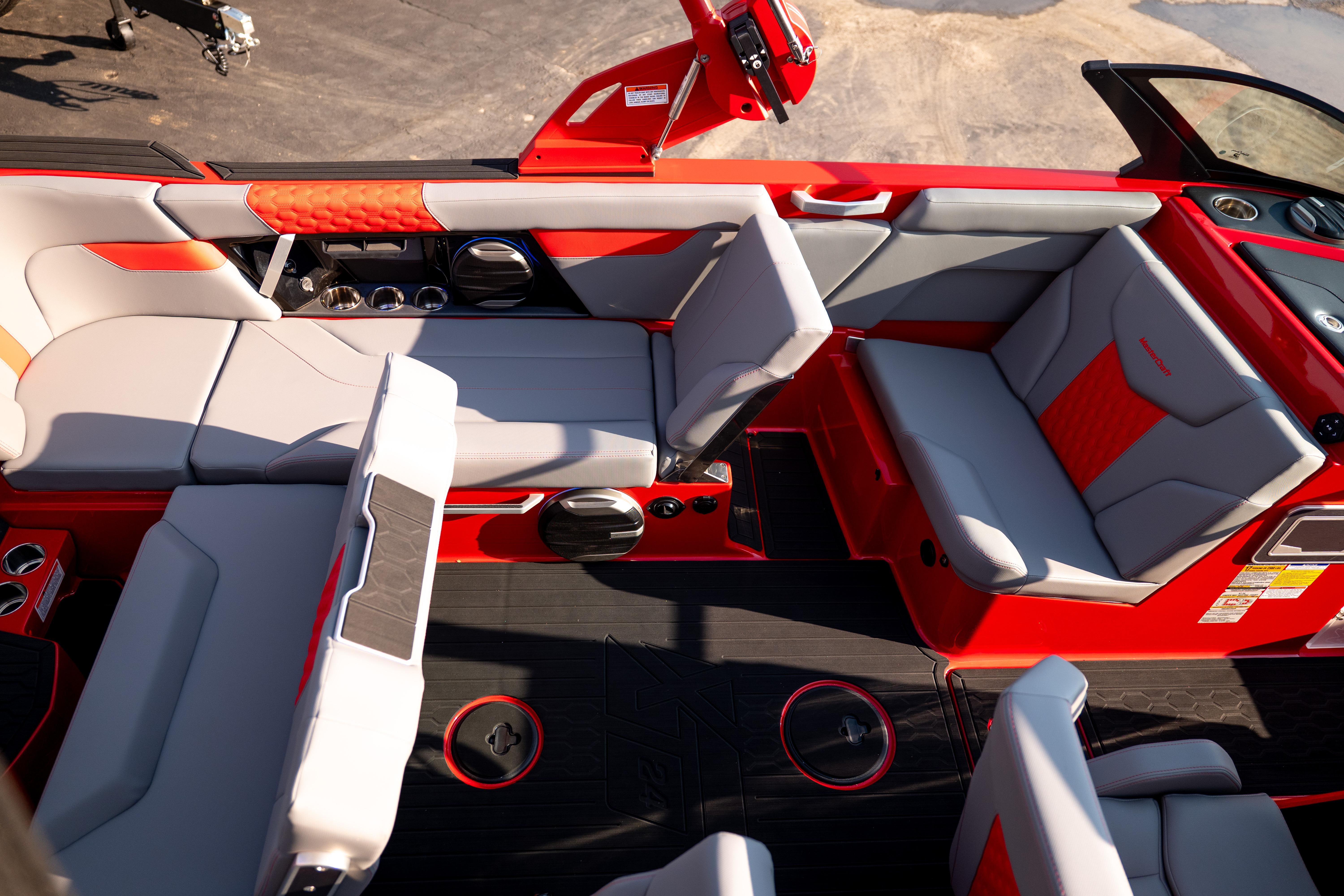 Interior of a 2027 MasterCraft XT24 boat with red and gray seating.
