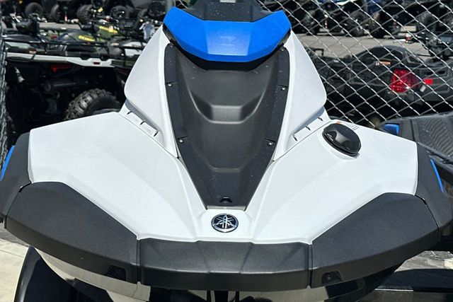 A Yamaha WaveRunner Jetblaster in black with blue accents, parked in front of a chain-link fence.