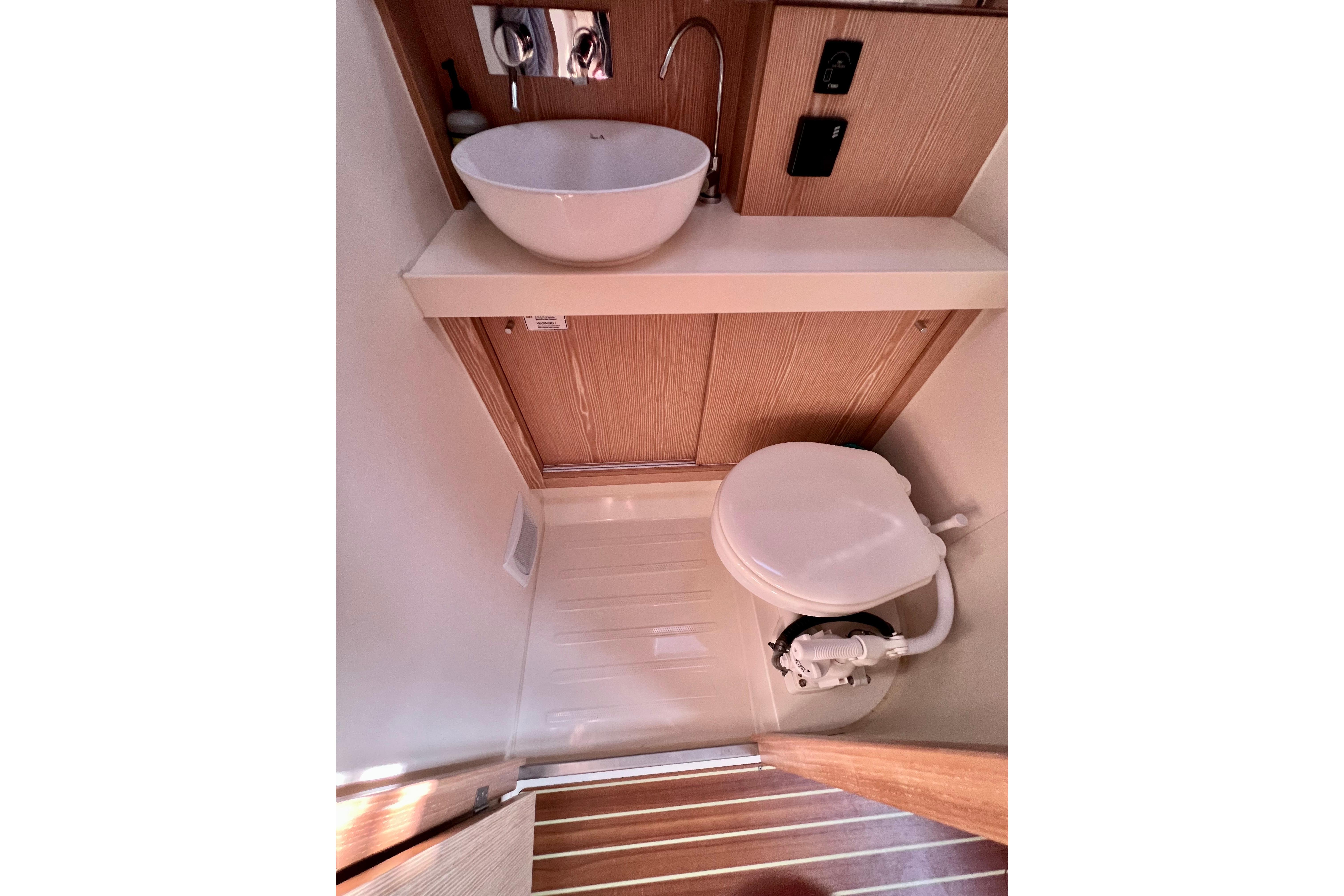 Modern bathroom in 2016 Hanse 455 yacht with sink and toilet.