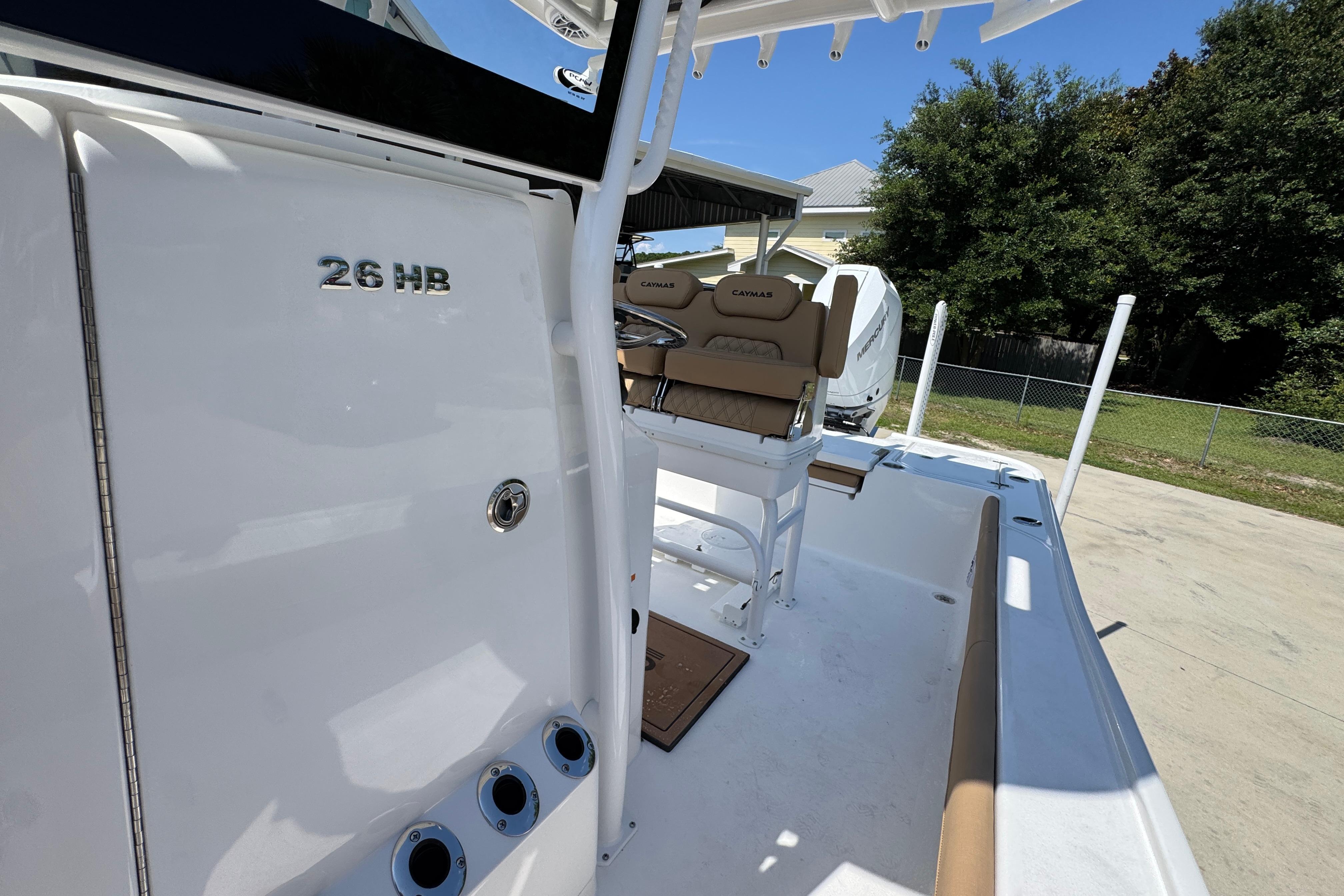 2027 Caymas 26 HB boat interior with seating and console, showcasing modern design.