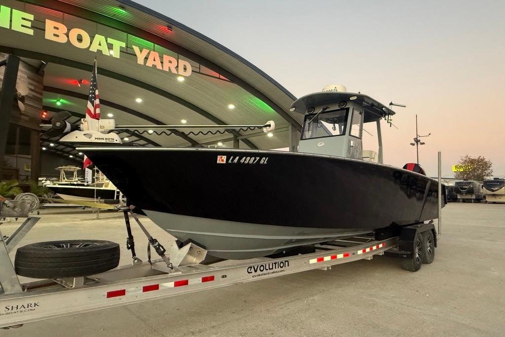 2019 Metal Shark 28 CC boat on trailer at dealership, evening view.