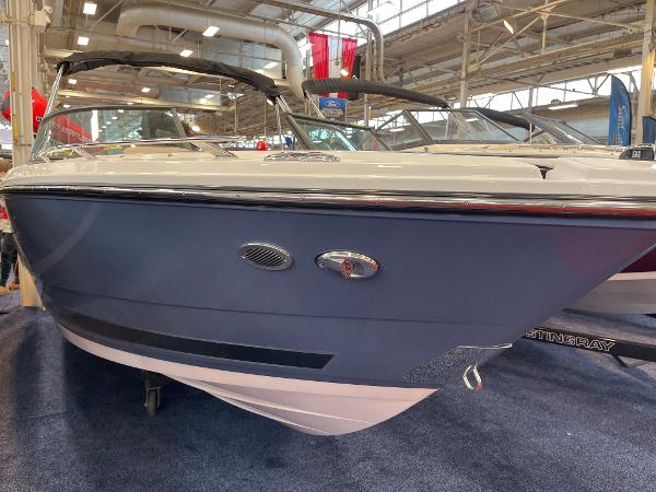 2025 Monterey 218 SS boat displayed indoors at a boat show.