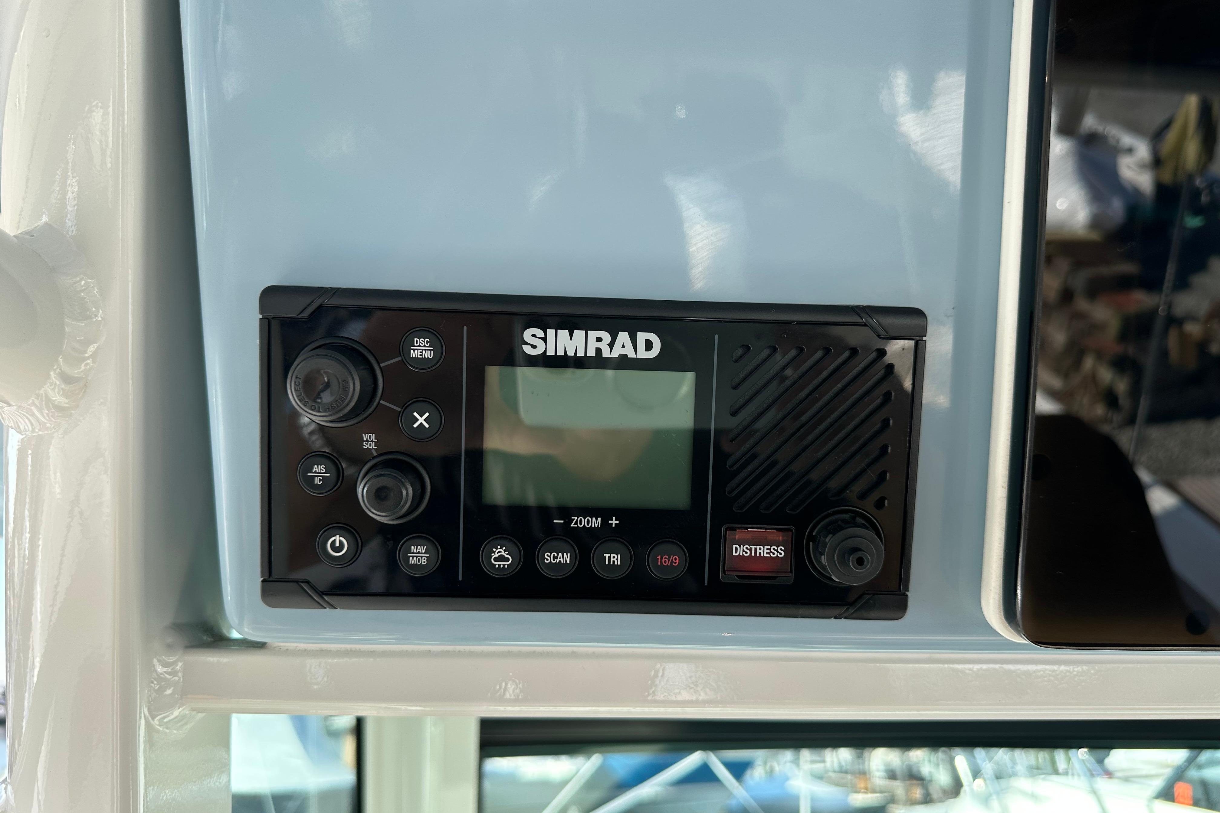 Simrad marine radio on 2023 Boston Whaler 330 Outrage boat dashboard.