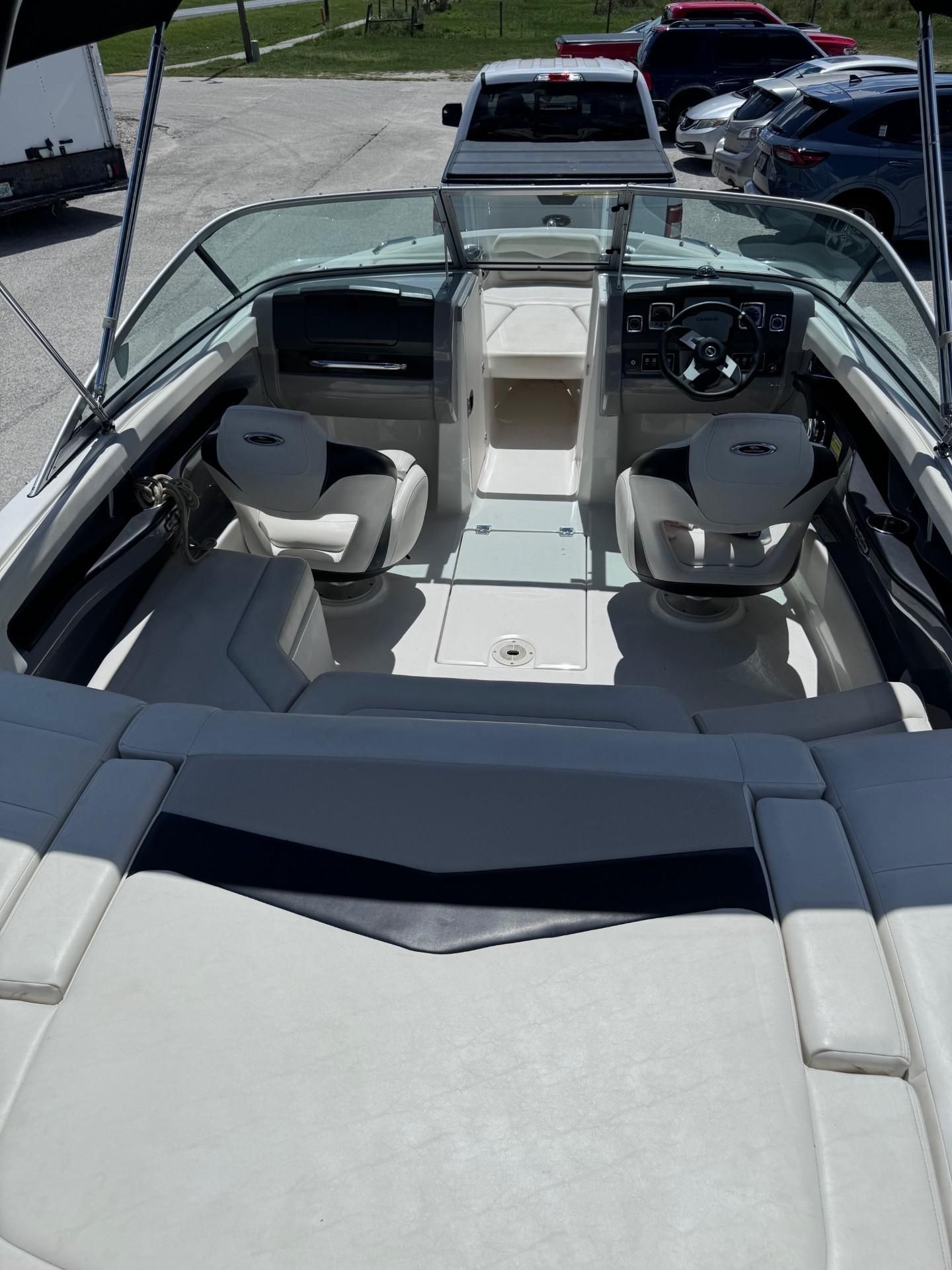 Interior view of a Chaparral 206 SSi boat with two seats and a helm station.