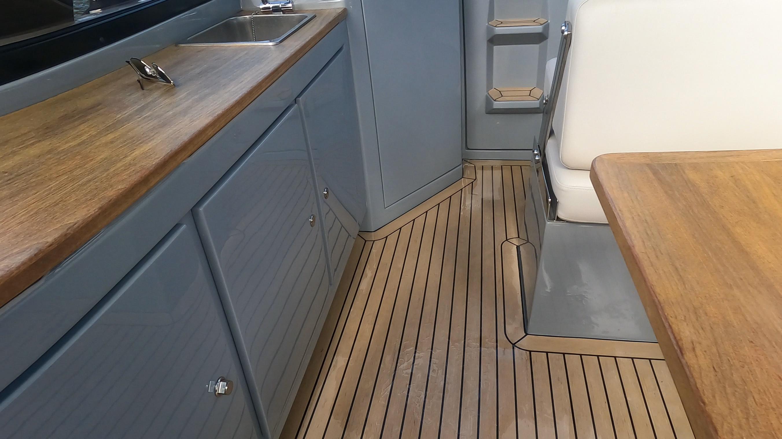 Interior of 2021 Rand Leisure boat with wooden flooring and modern cabinetry.