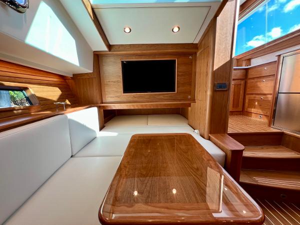 Luxurious interior of 2025 Sabre 43 Salon Express yacht with wood finishes and seating area.
