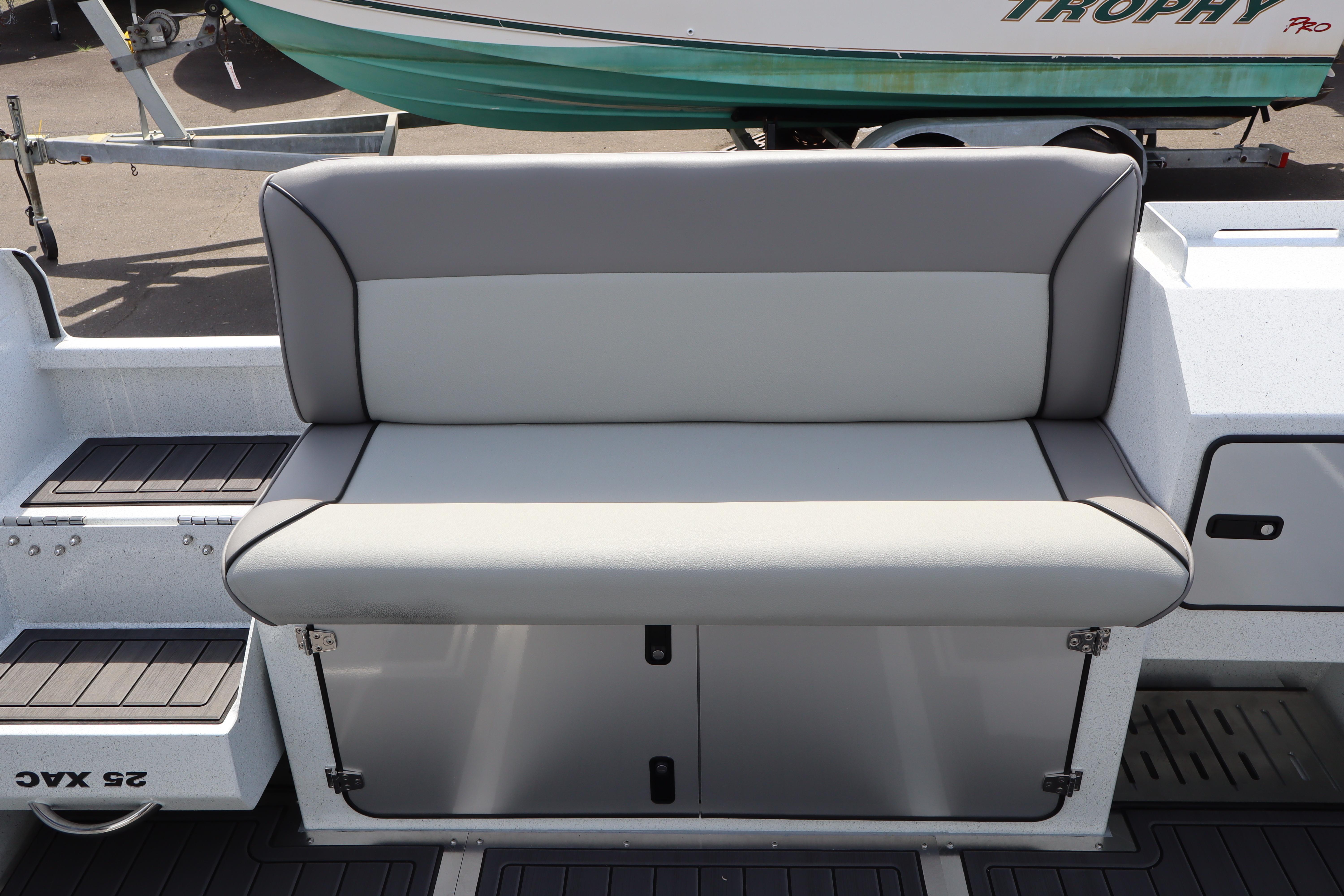 KingFisher 25 XAC 2026 boat seat with storage compartment, gray upholstery.