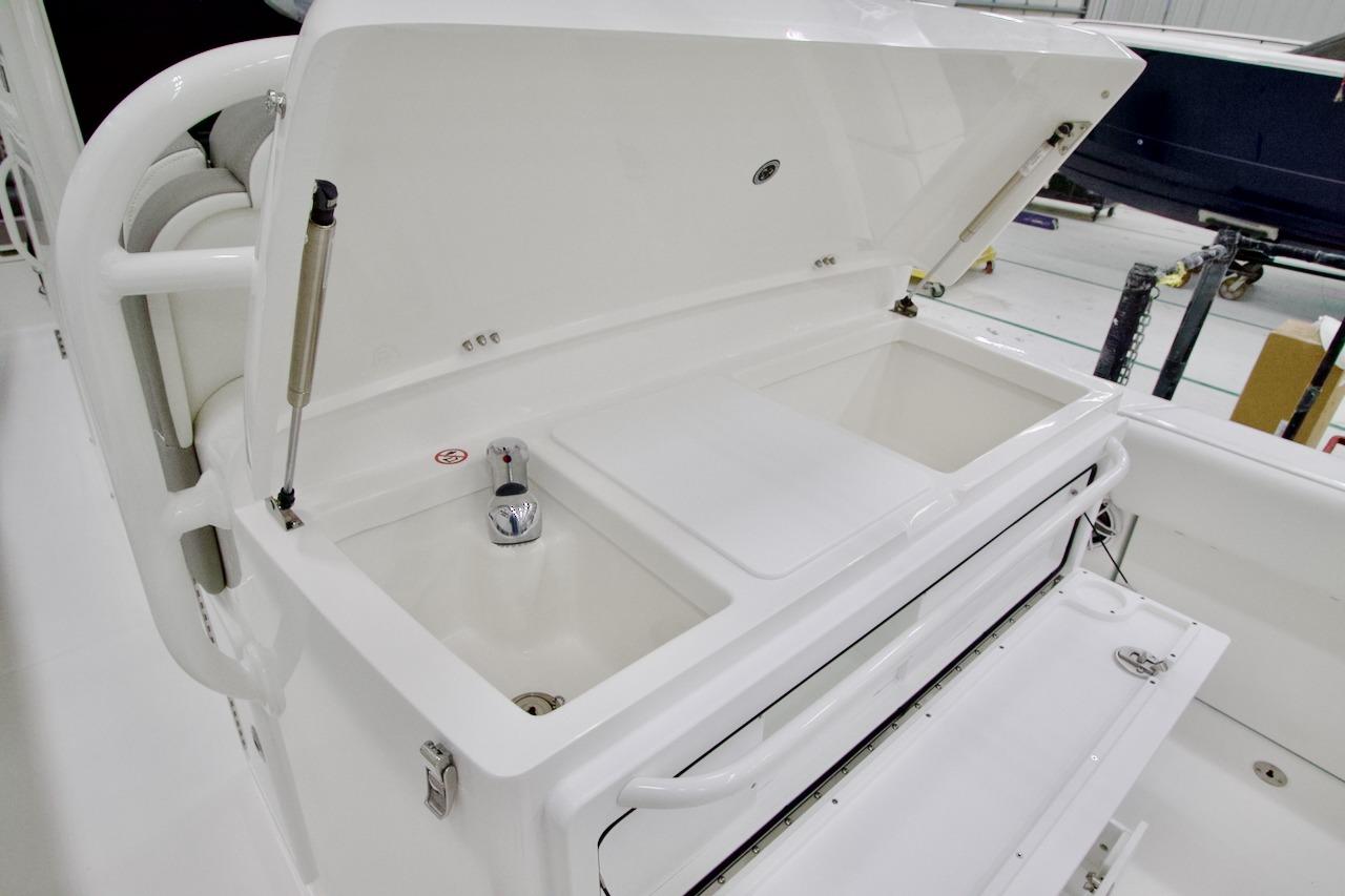 2026 Regulator 31 boat interior with open storage compartment and faucet.
