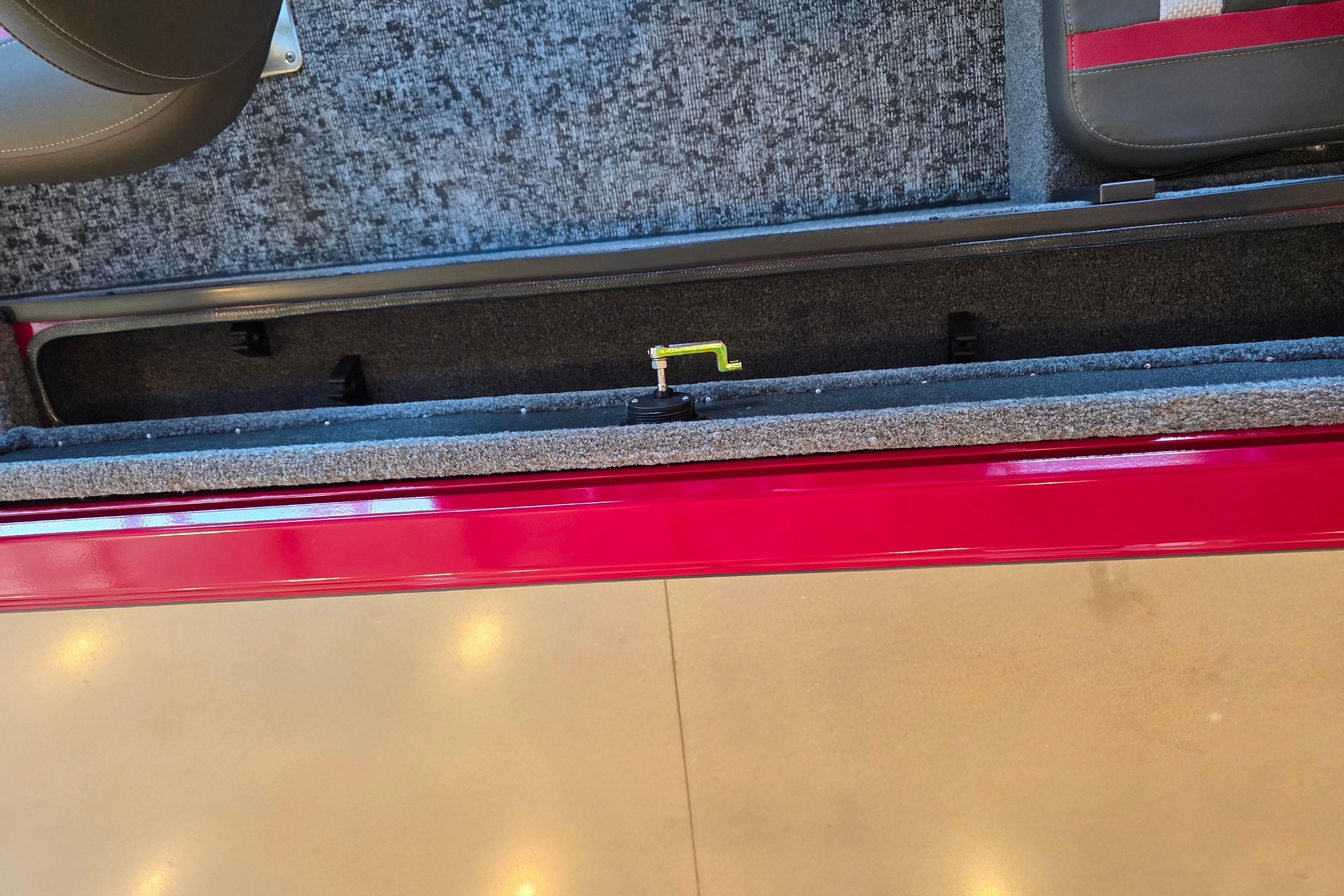 2026 Ranger VS1782SC Reata boat interior storage compartment with red trim and carpeted flooring.
