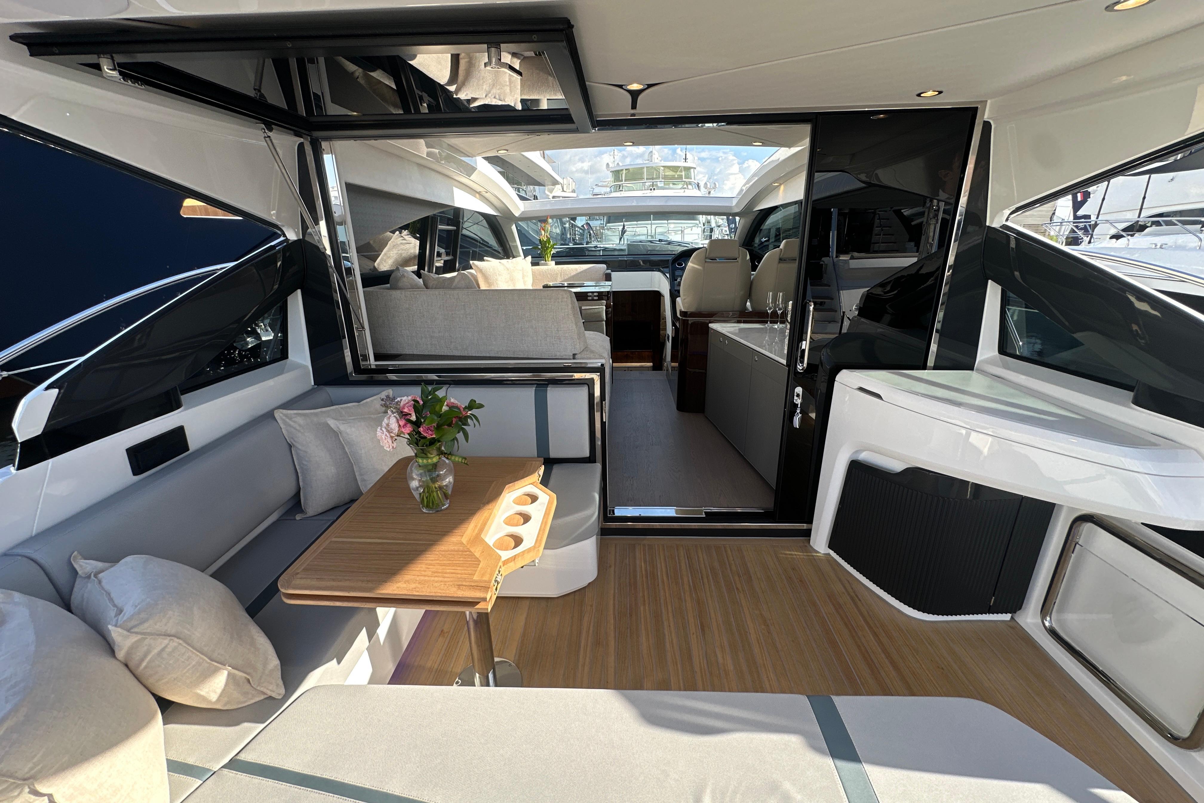 Luxurious interior of 2026 Fairline Targa 47 GT yacht with elegant seating and table.