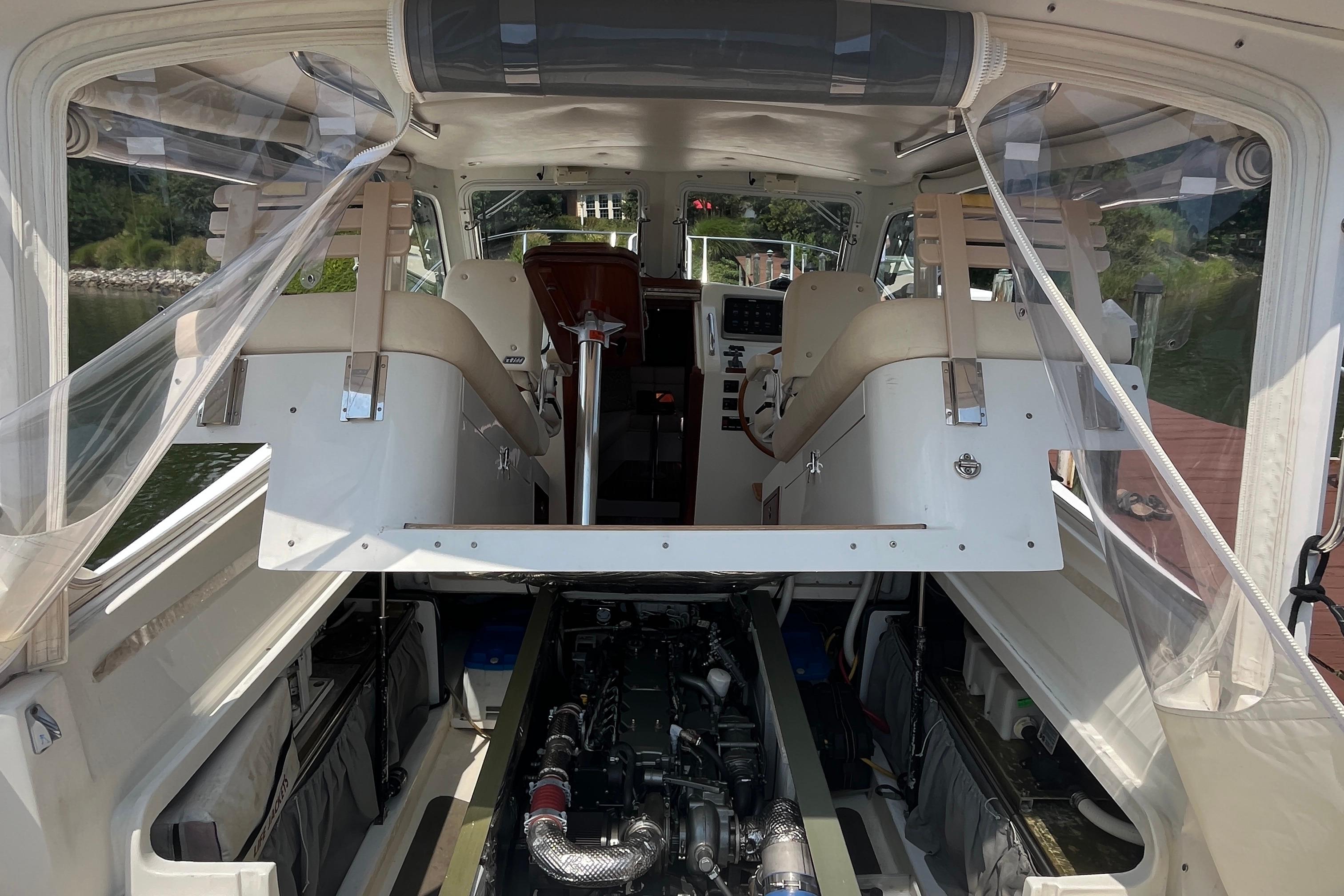 Interior view of a 2006 MJM 34z boat showcasing seating and engine compartment.