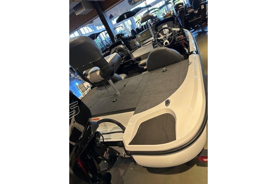 2026 Nitro Z17 boat interior with seating and steering console in showroom.