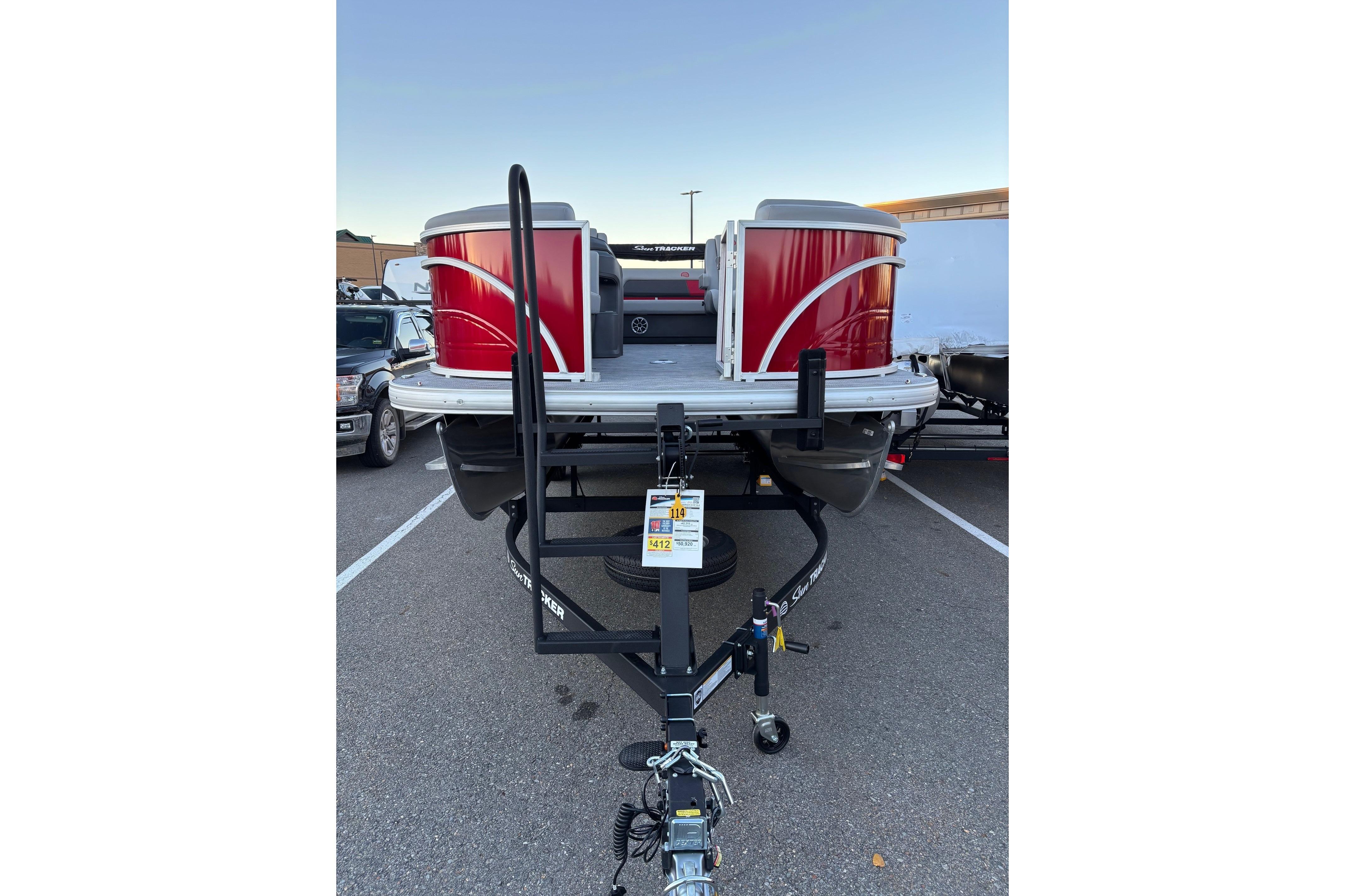 2026 Sun Tracker Party Barge 22 RF DLX pontoon boat on trailer, red exterior.