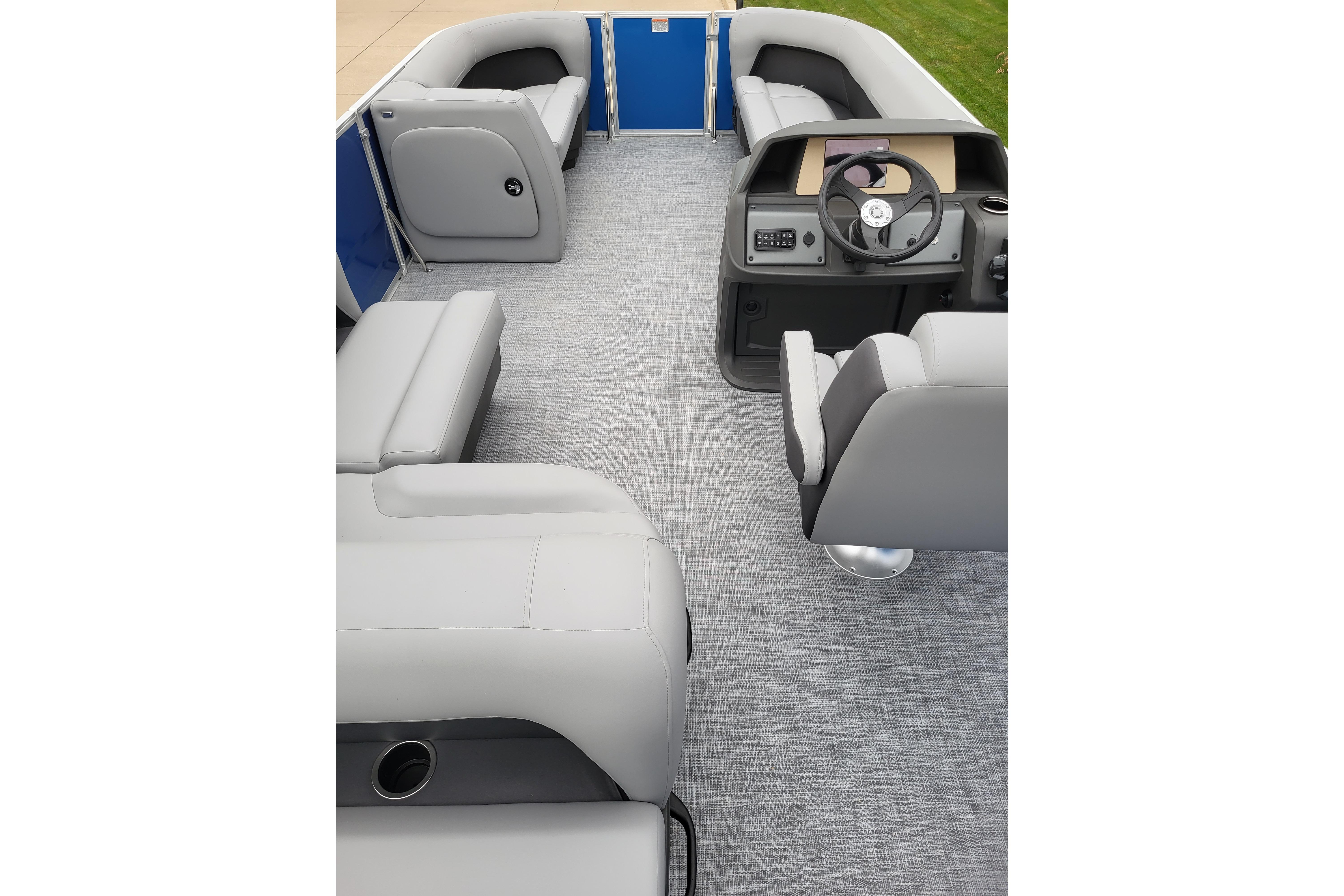 2026 Sun Tracker Party Barge 18 DLX interior with gray seating and steering console.