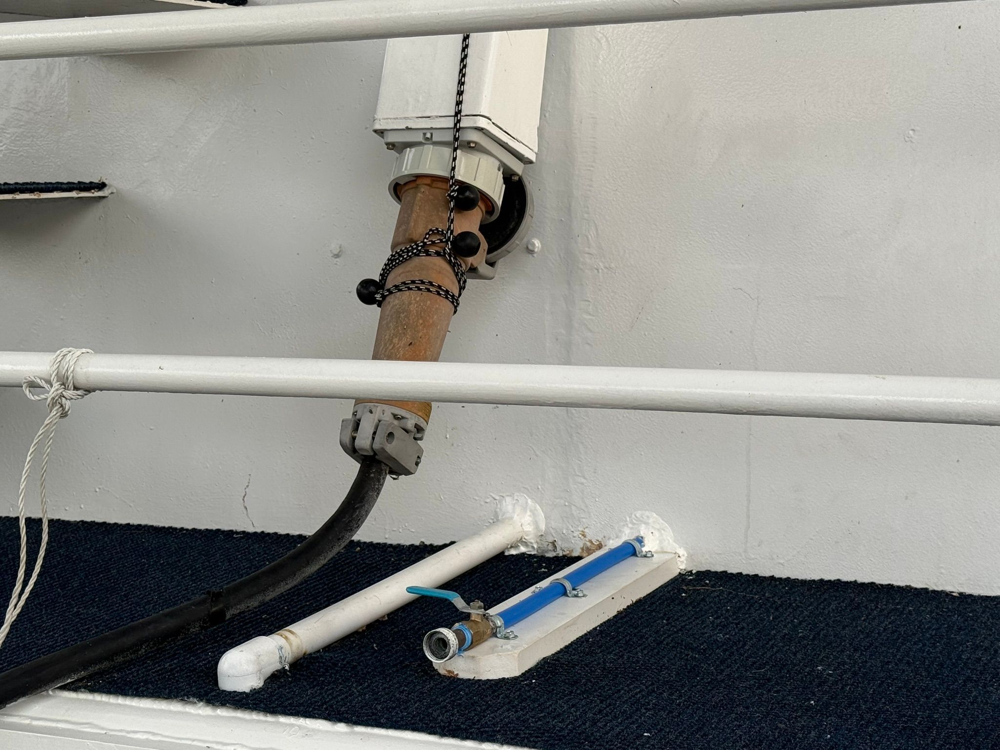 Close-up of a boat deck with pipes and valves.