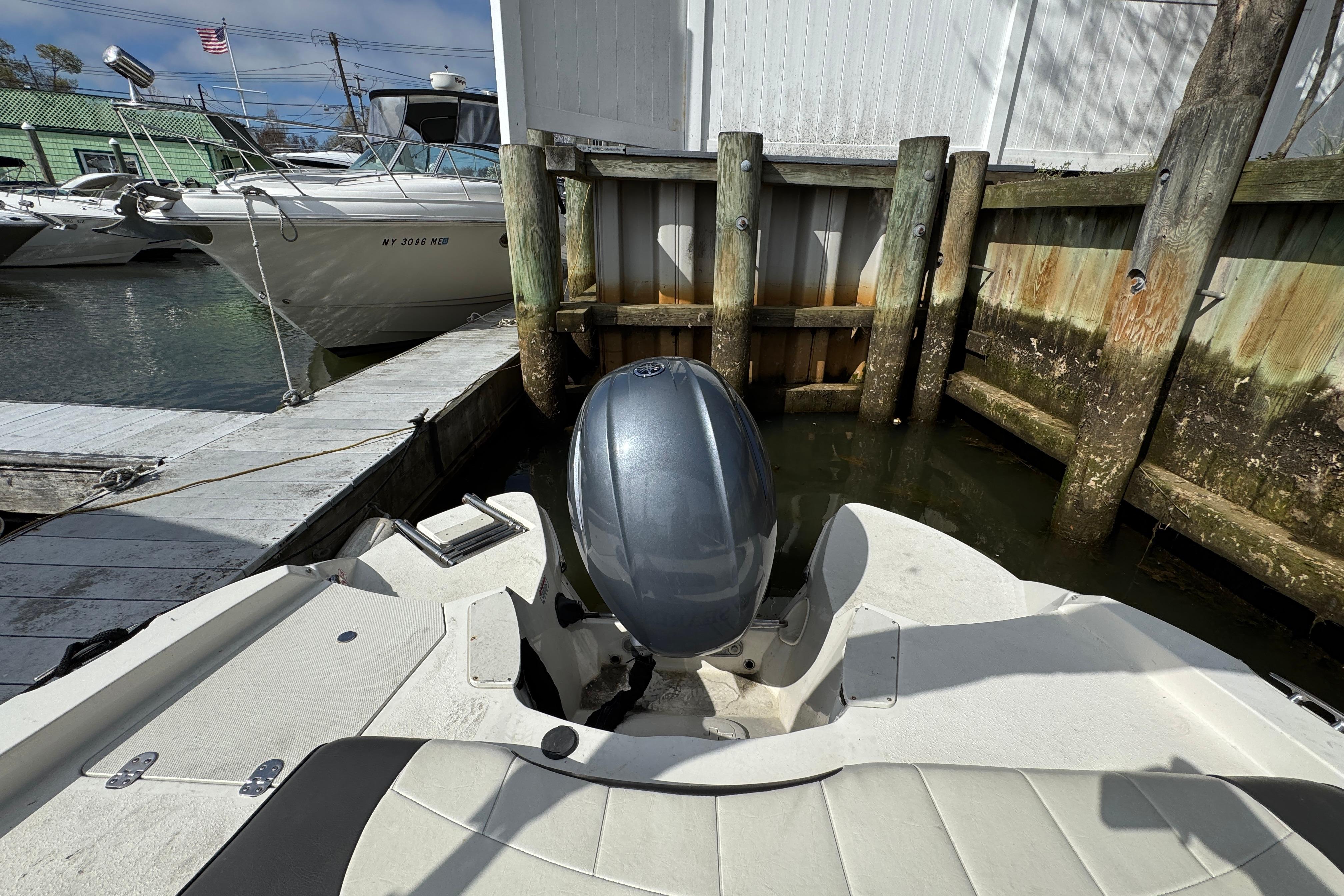 2019 Stingray 204 LR boat docked at marina with outboard motor.