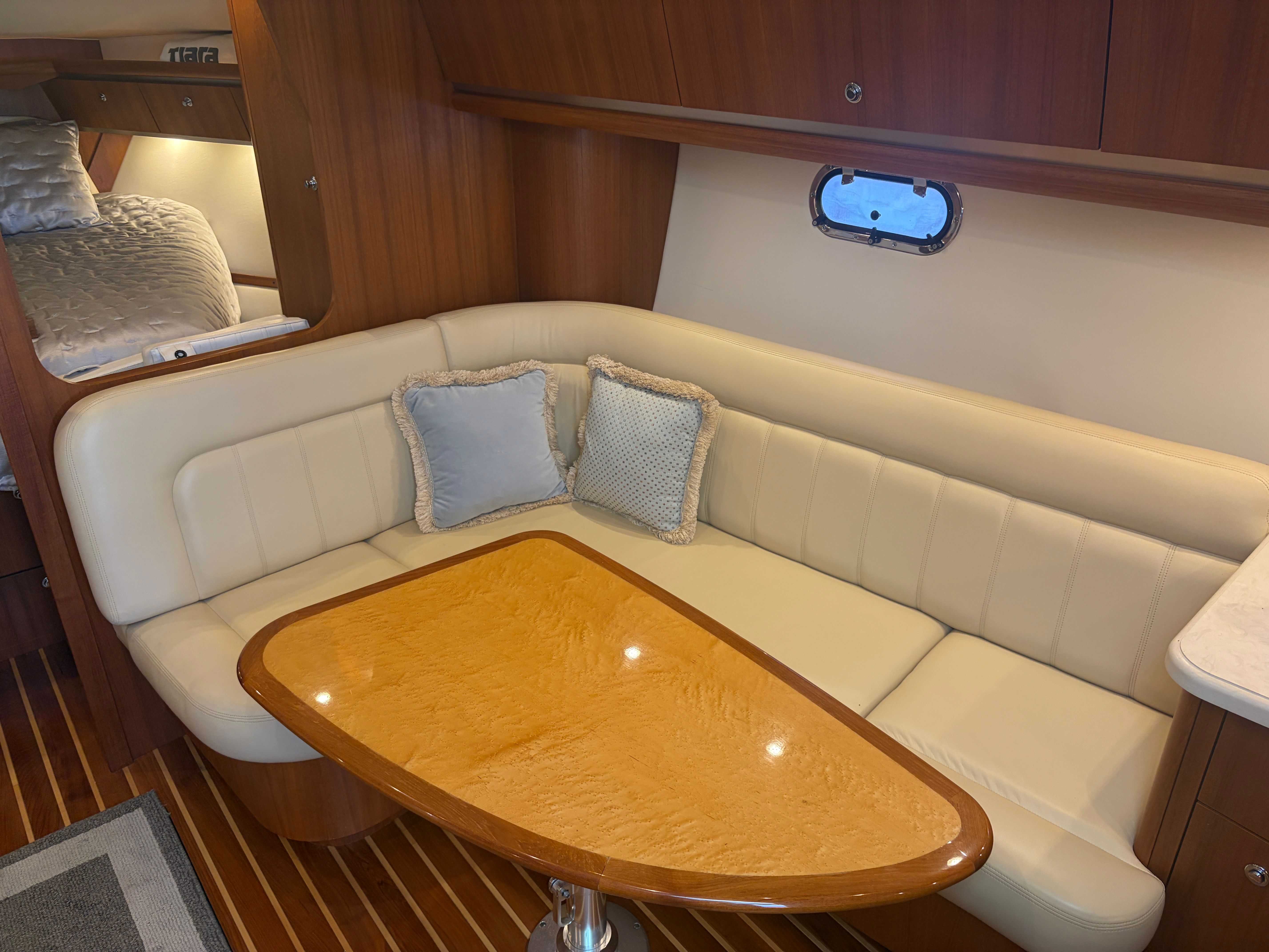 Interior of 2005 Tiara Yachts Sovran with leather sofa and wooden table.
